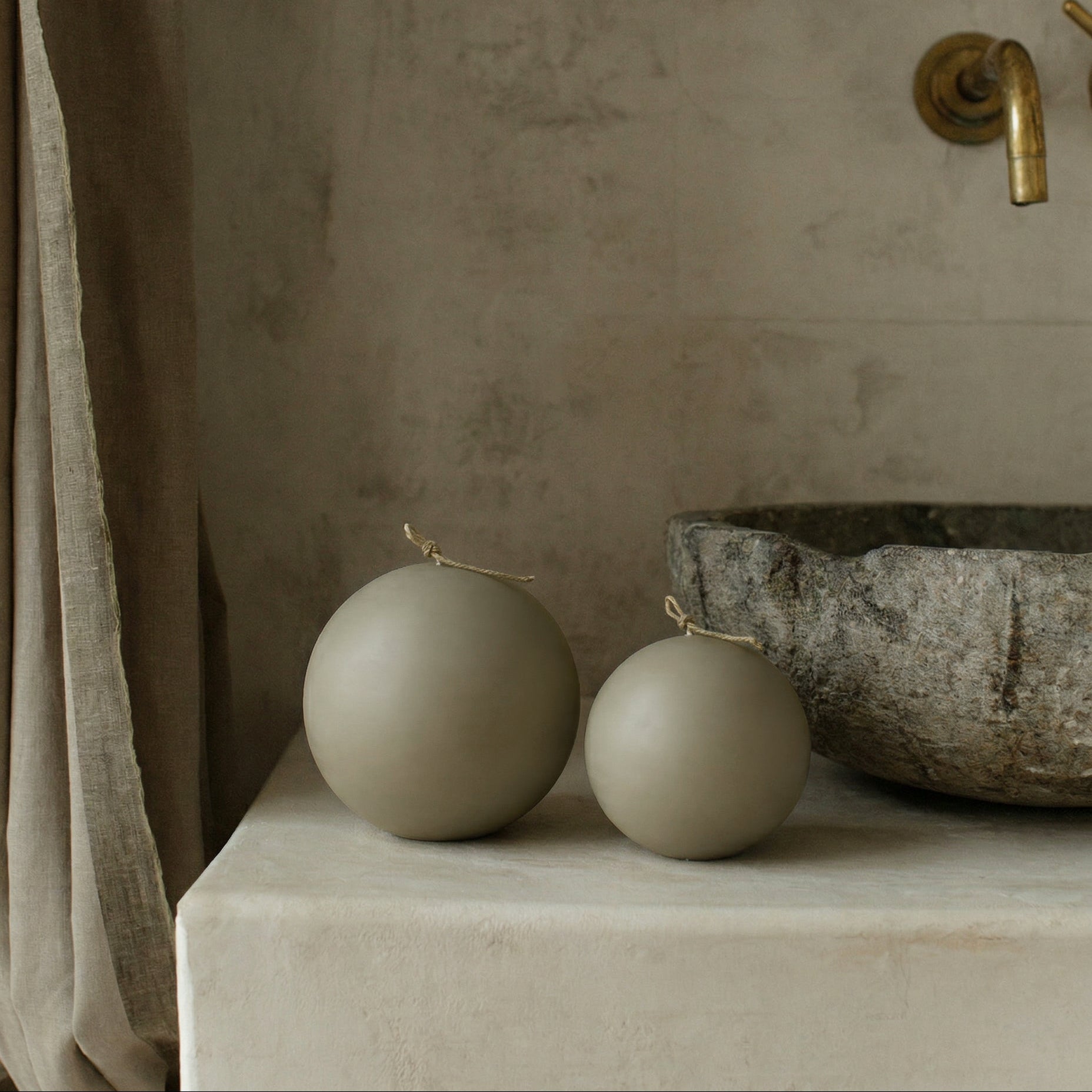 Handmade sphere sculptural candle made from premium soy wax on minimalist surface in Los Angeles studio setting