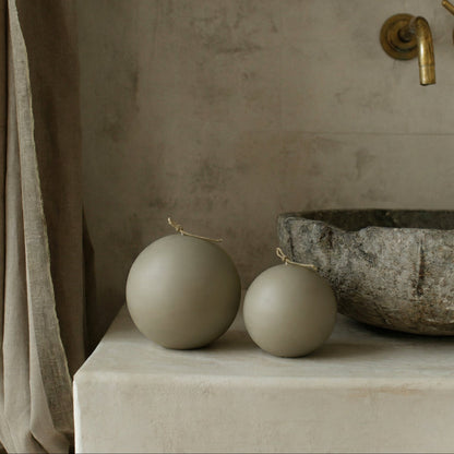 Handmade sphere sculptural candle made from premium soy wax on minimalist surface in Los Angeles studio setting