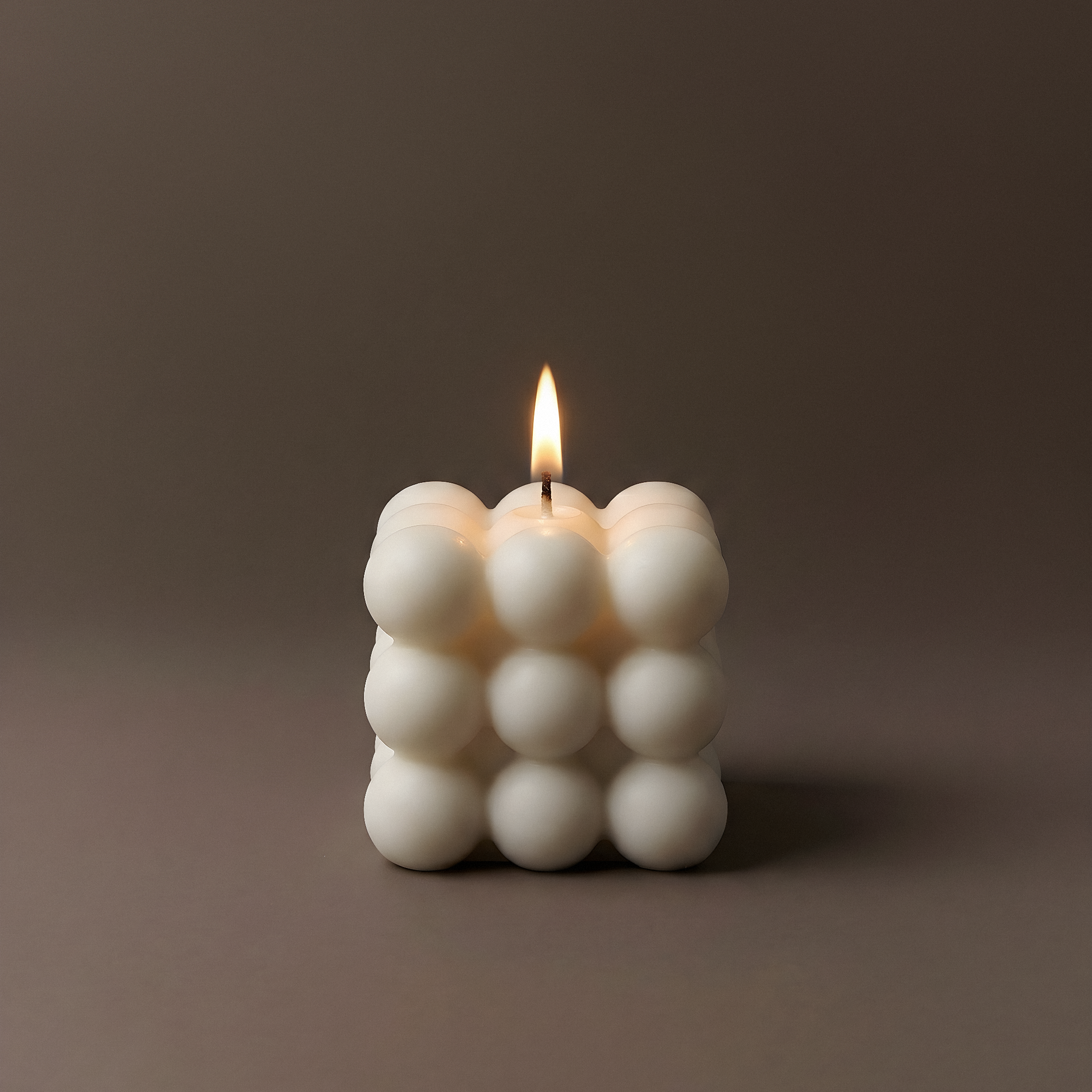 White bubble sculptural candle made from premium soy wax handmade in Los Angeles on neutral background