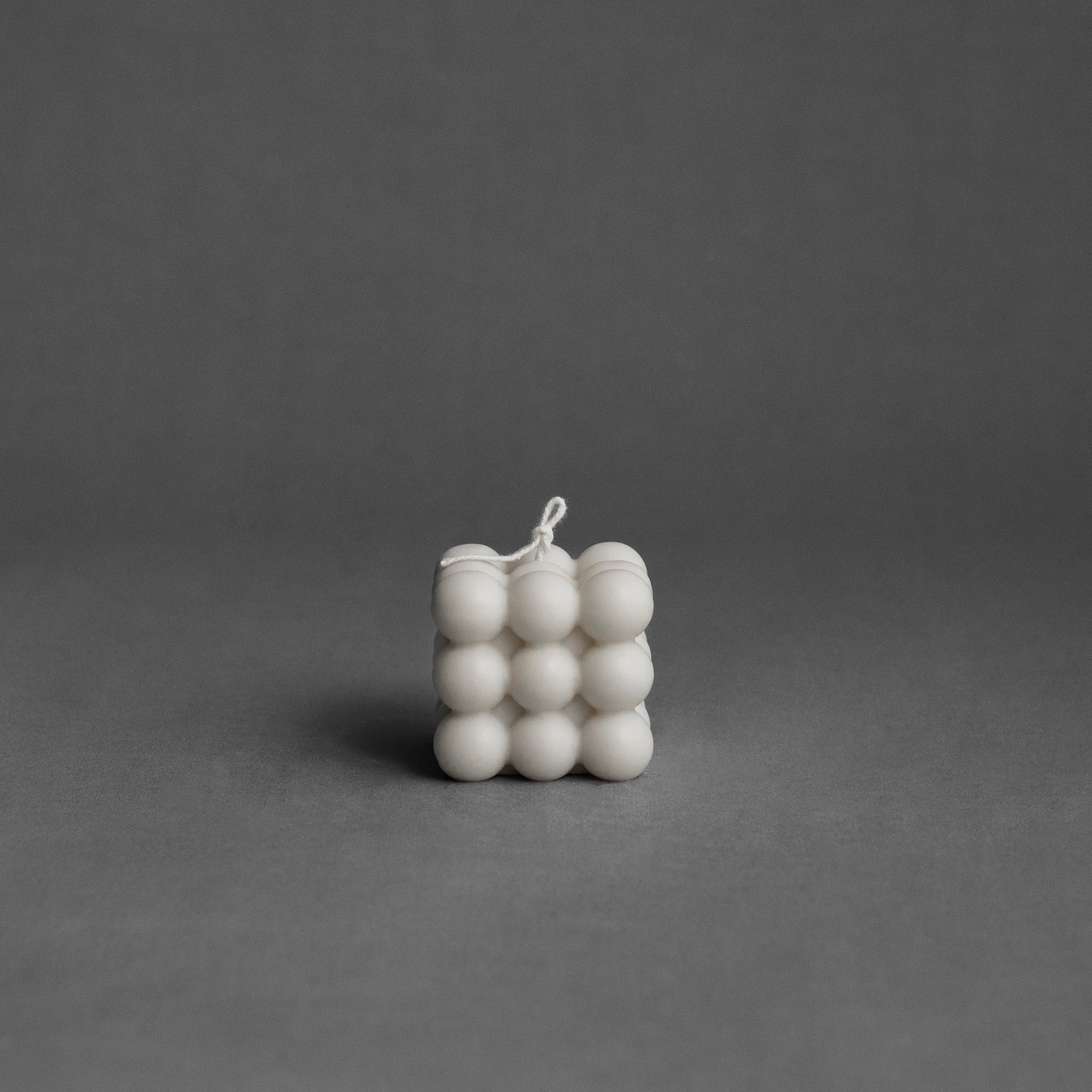 White bubble pillar candle by LAWA featuring rounded sculptural bubbles in soy wax