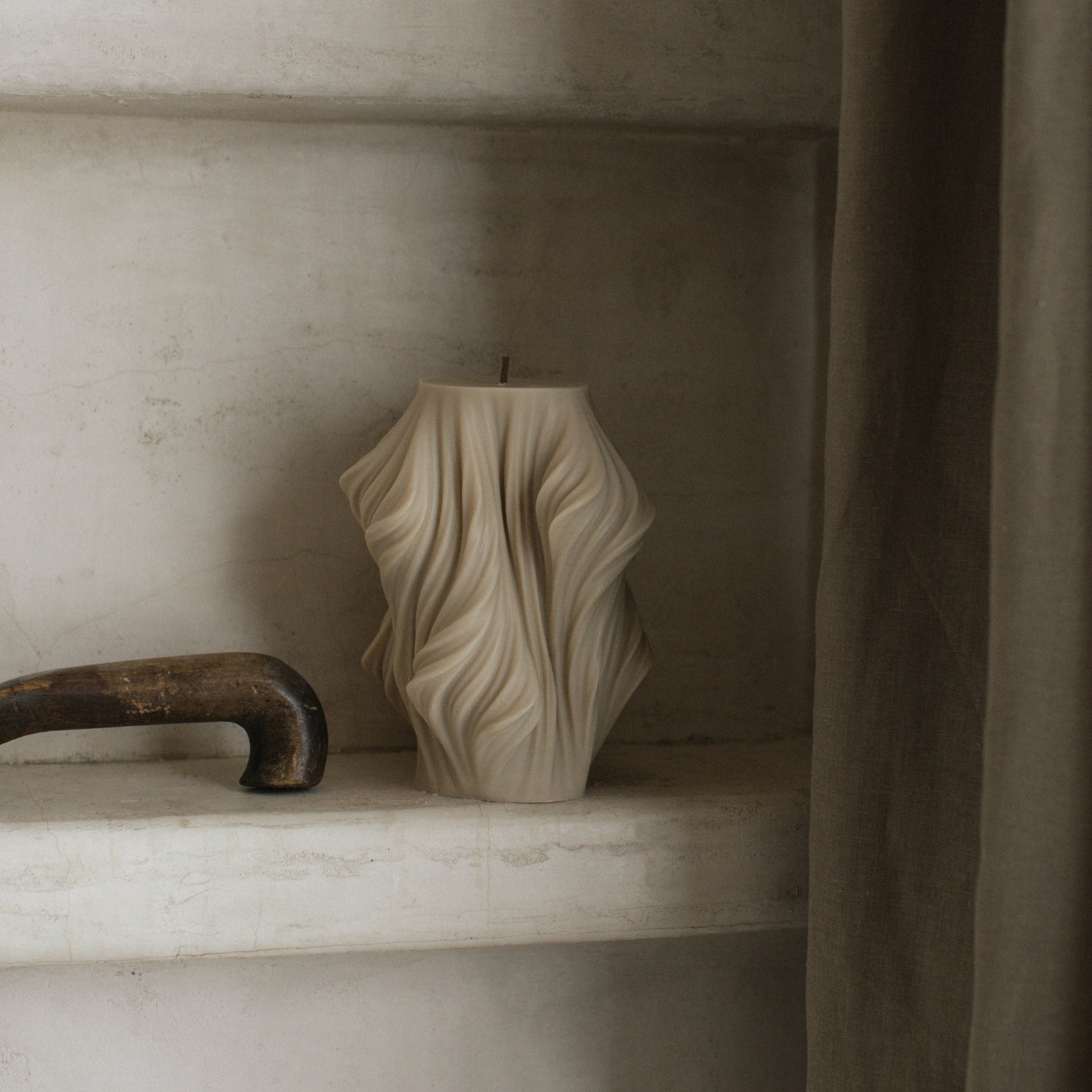 Close-up detail of handmade sculptural candle showing cascading wave texture in premium soy wax from Los Angeles