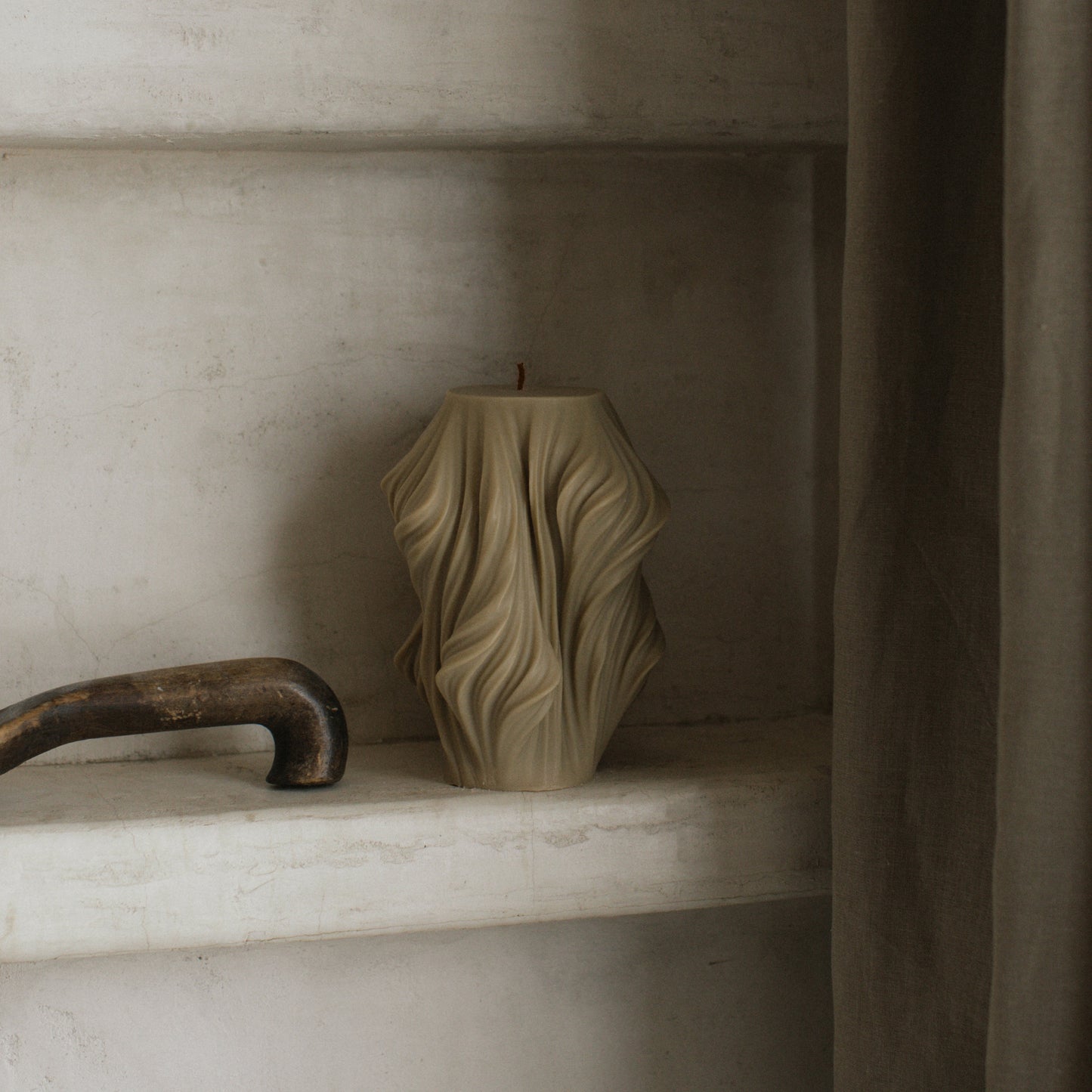 Close-up detail of handmade sculptural candle with cascading wave texture in premium soy wax from Los Angeles