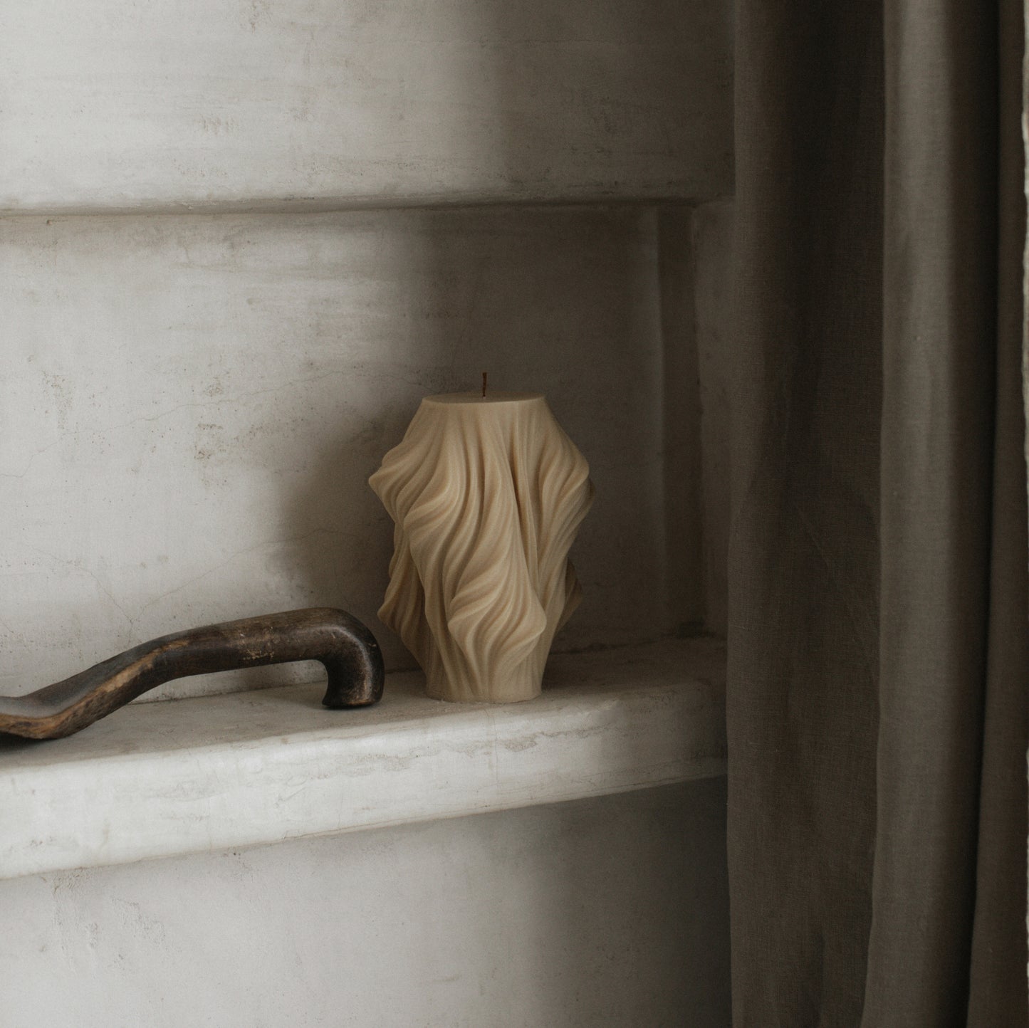 Close-up detail of handmade sculptural candle showing textured wave design in premium soy wax from Los Angeles