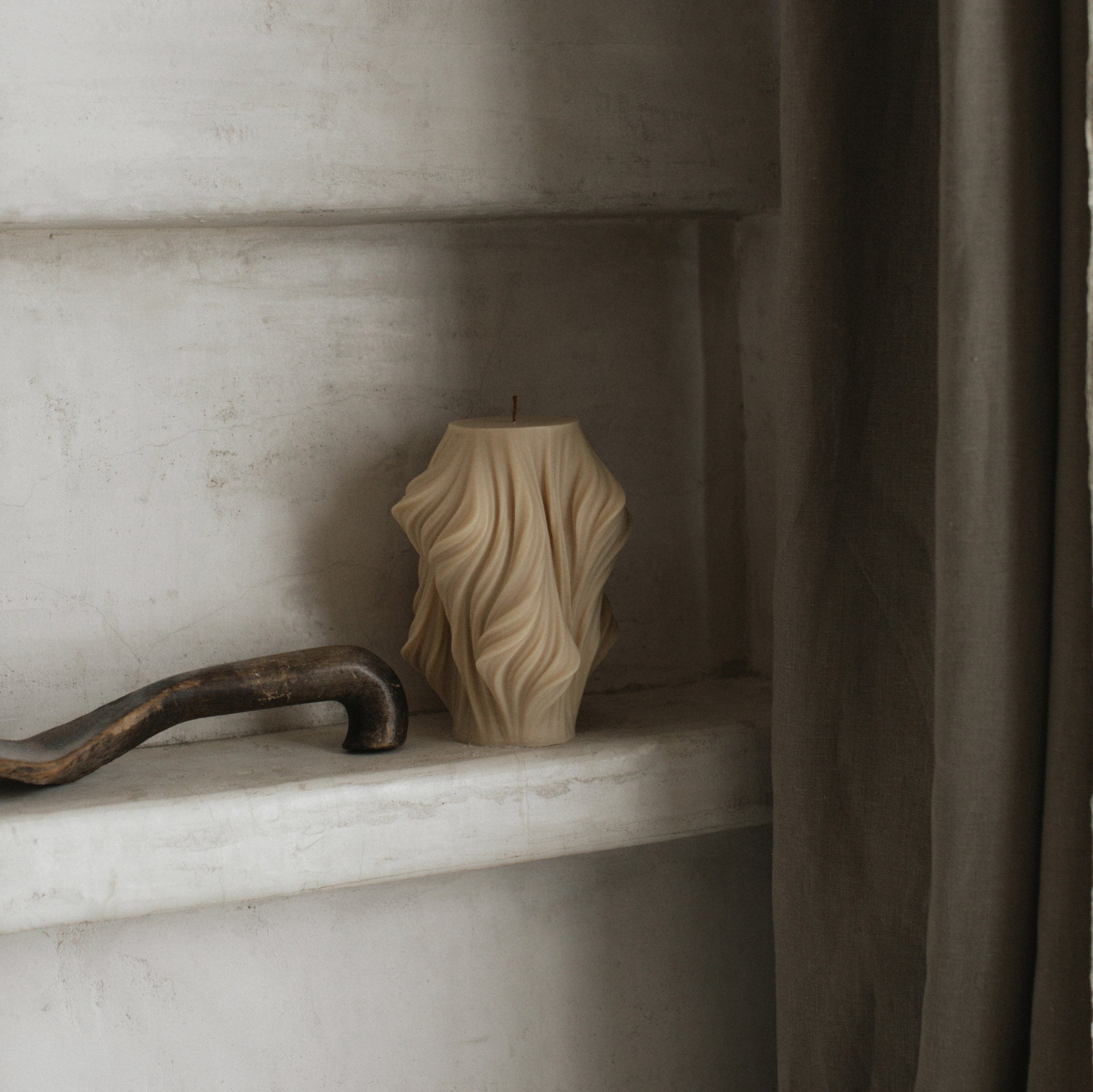 Sandstone large cascading pillar candle featuring stepped geometric lines