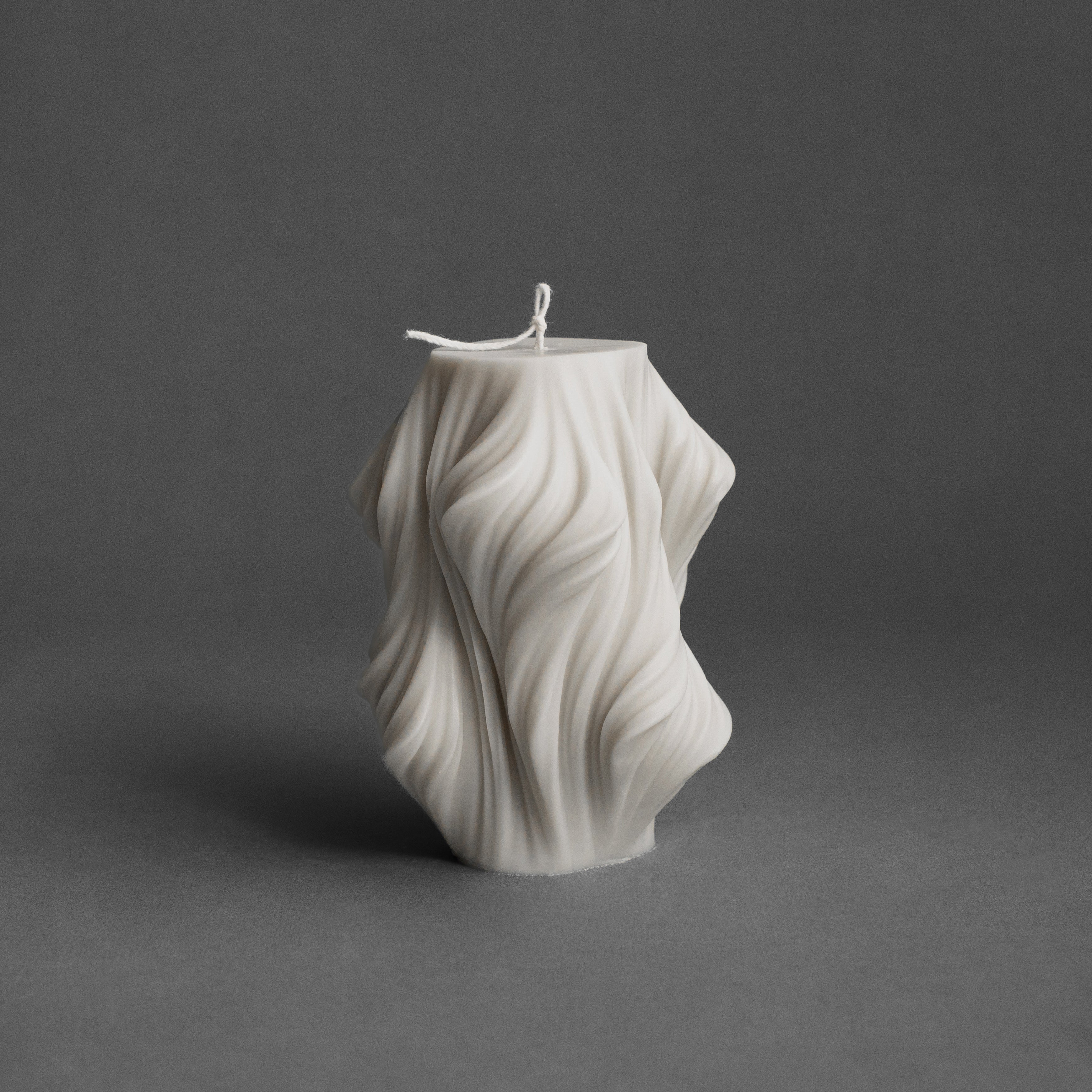 White cascading large pillar candle by LAWA featuring bold tiered sculptural shape