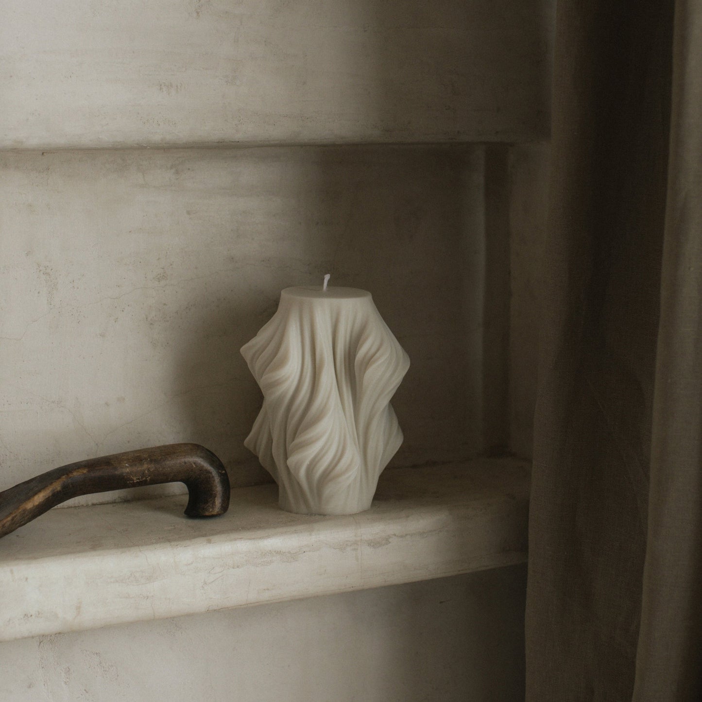 Close-up detail of handmade sculptural candle showing cascading wave texture in premium soy wax from Los Angeles