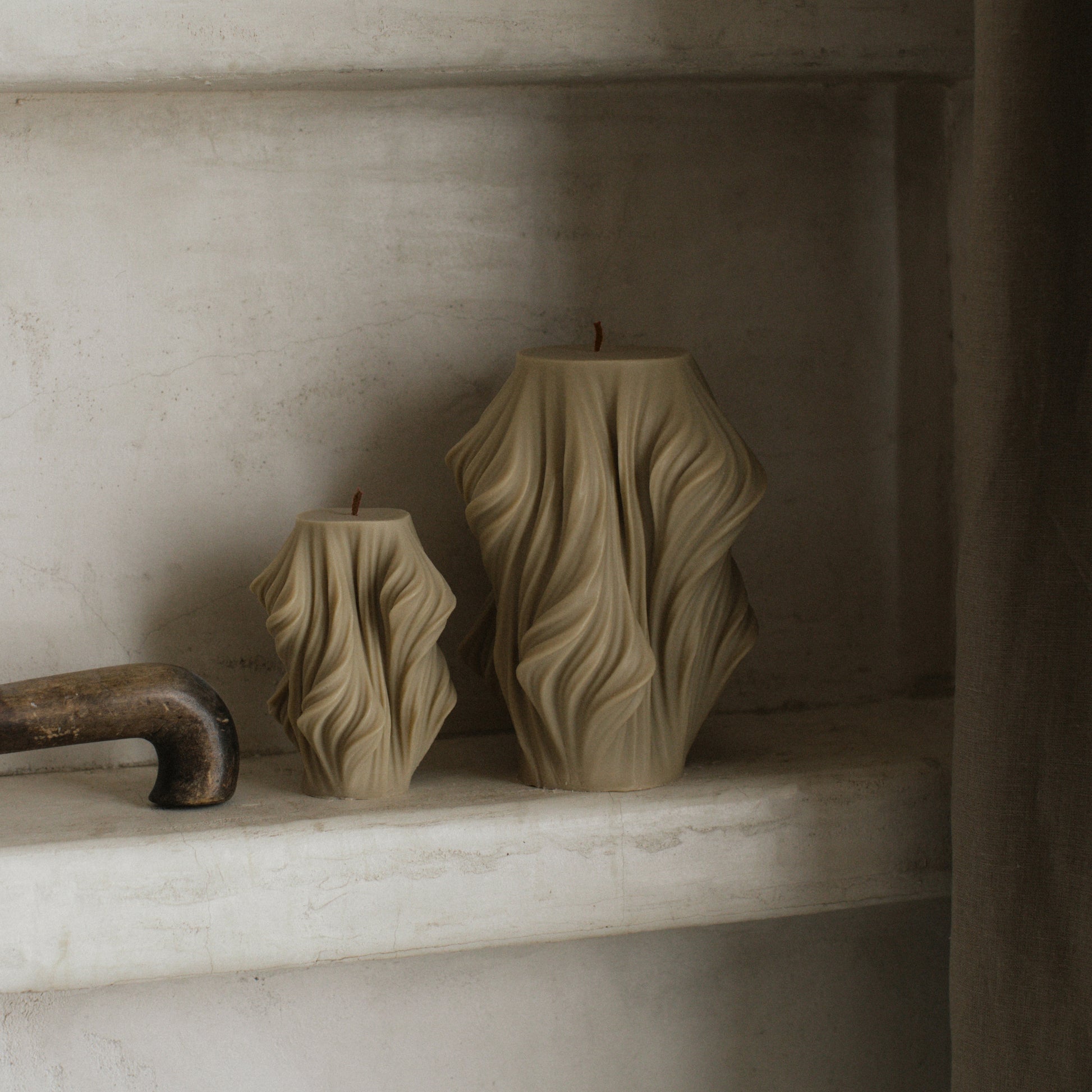 Close-up detail of handmade Cascading Wave sculptural candle showing flowing soy wax texture and smooth finish
