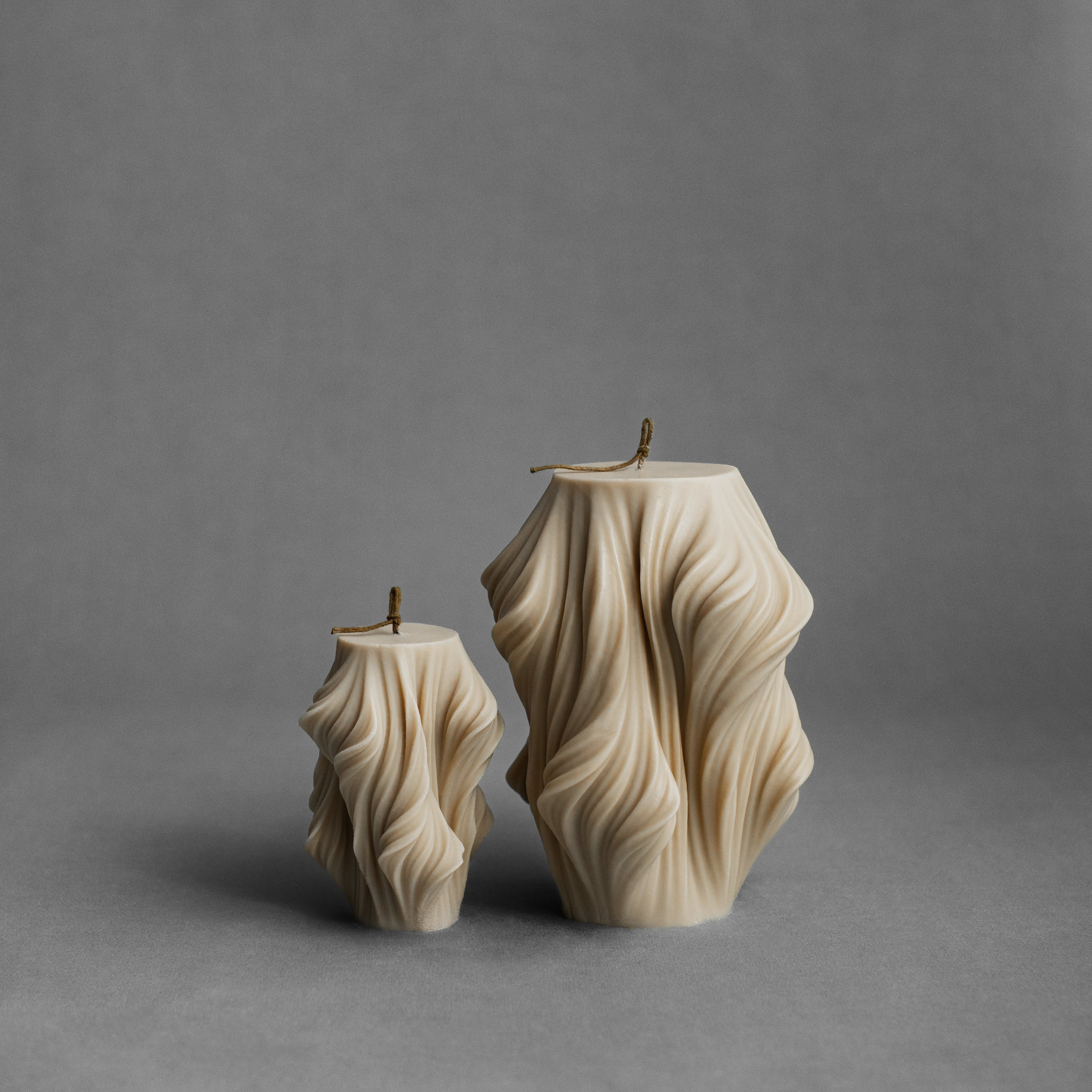 Sandstone cascading set of 2 pillar candles by LAWA with warm neutral stepped texture