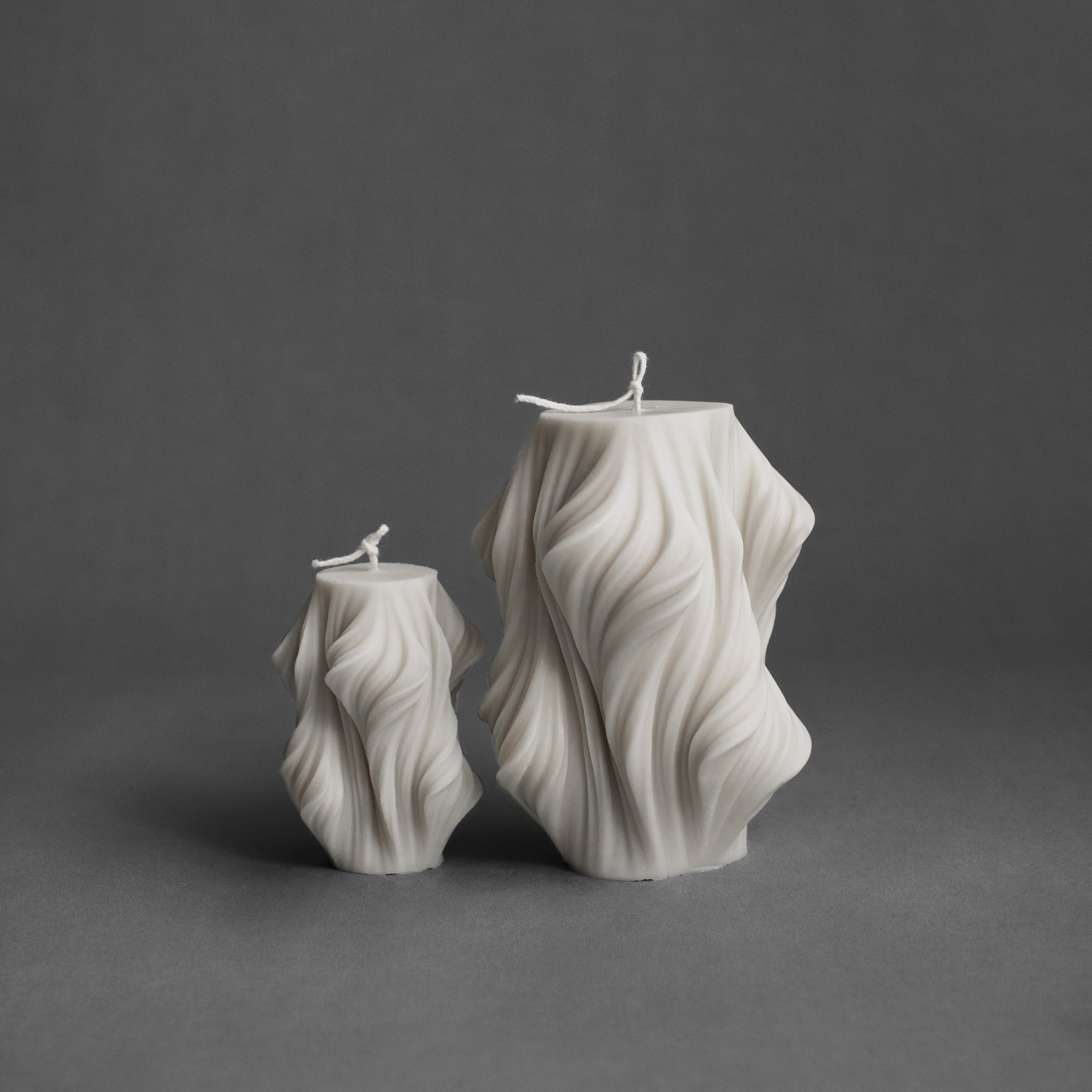 White cascading set of 2 pillar candles by LAWA with matching sculptural stepped shapes