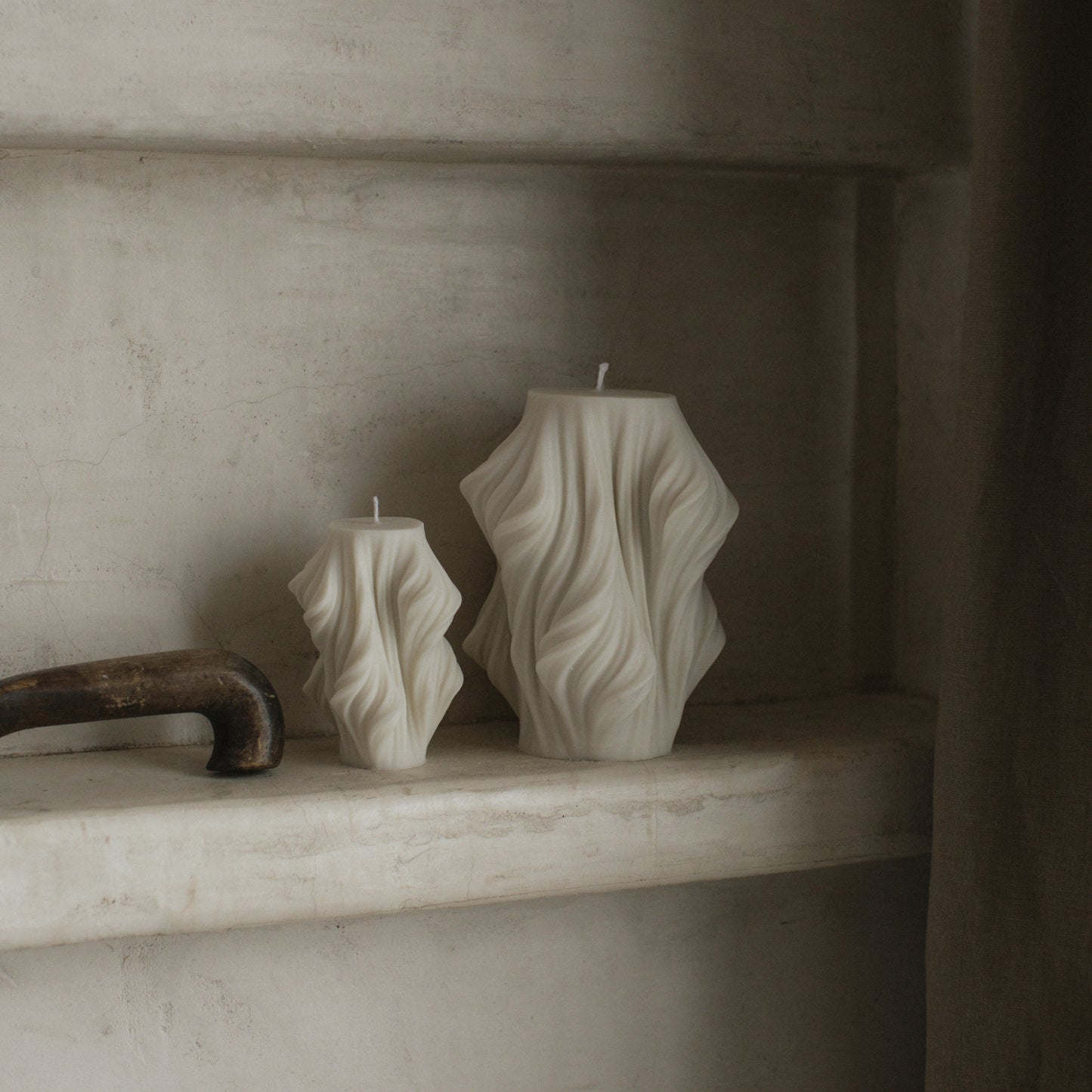 Close-up detail of handmade sculptural candle showing cascading wave texture in premium soy wax from Los Angeles