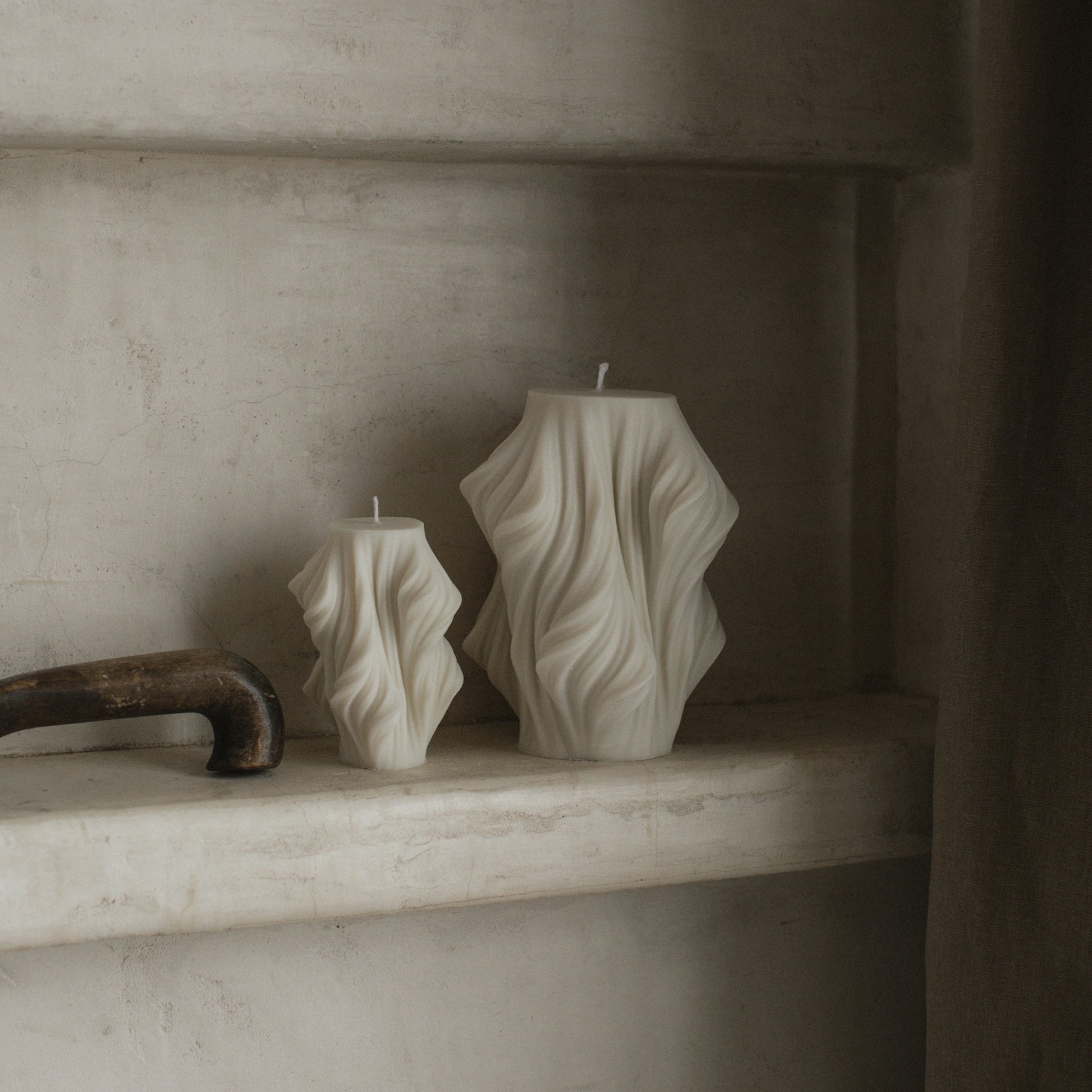 Close-up detail of handmade sculptural candle showing cascading wave texture in premium soy wax from Los Angeles