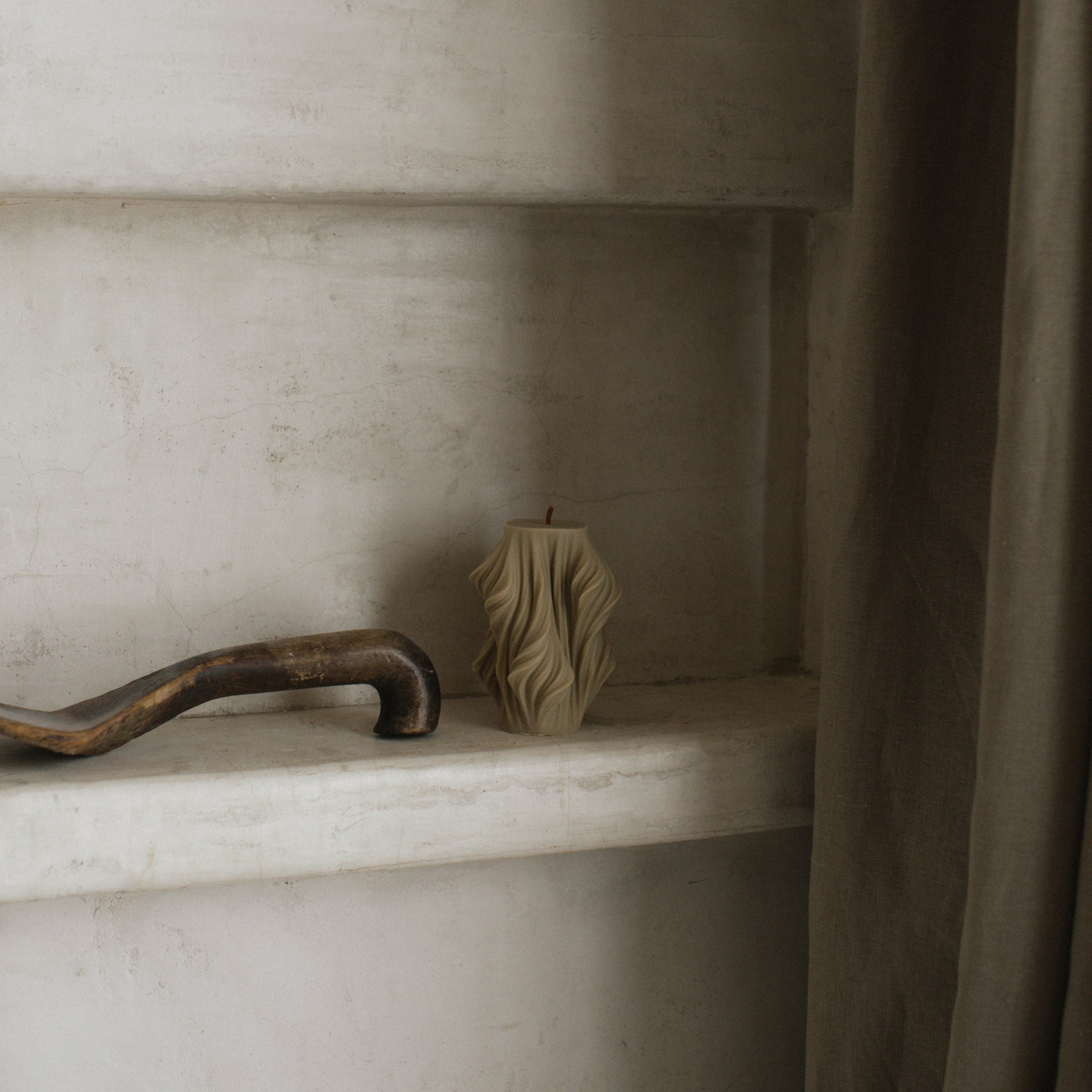 olive beige small cascading pillar candle featuring modern layered shape