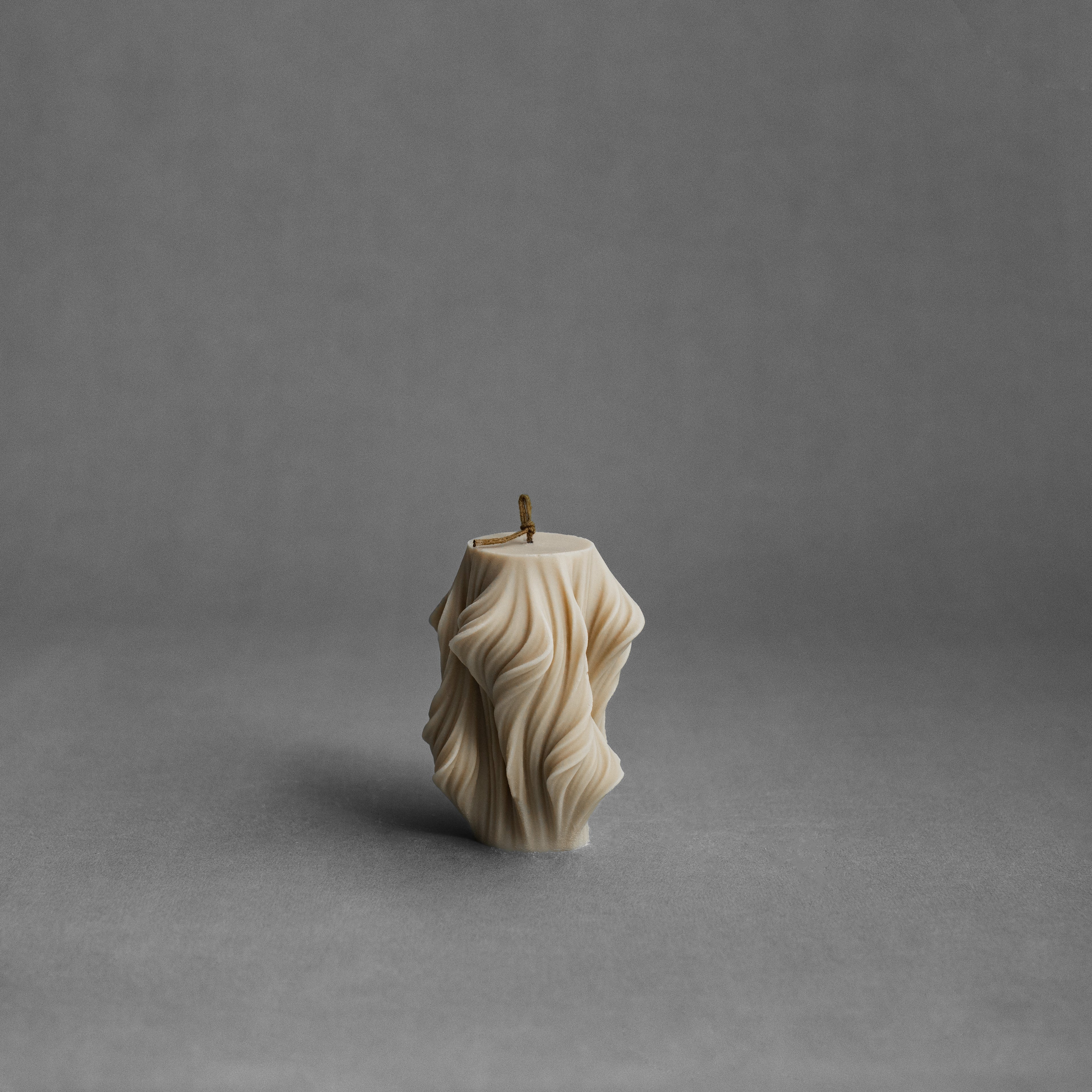 Sandstone cascading small pillar candle by LAWA with warm neutral layers