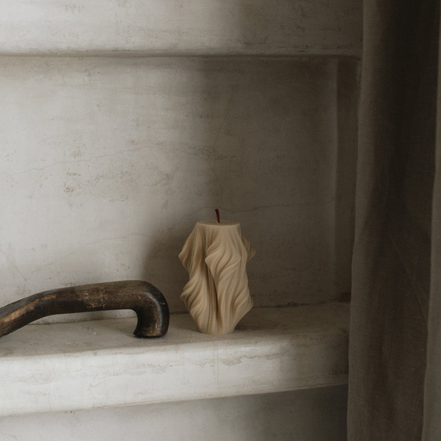 Close-up detail of handmade sculptural candle with cascading wave texture in premium soy wax from Los Angeles