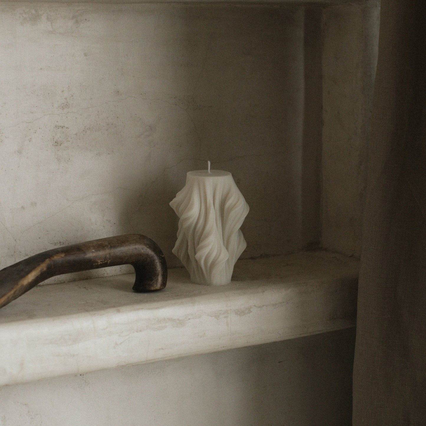 Close-up detail of handmade sculptural candle showing cascading wave texture in premium soy wax from Los Angeles