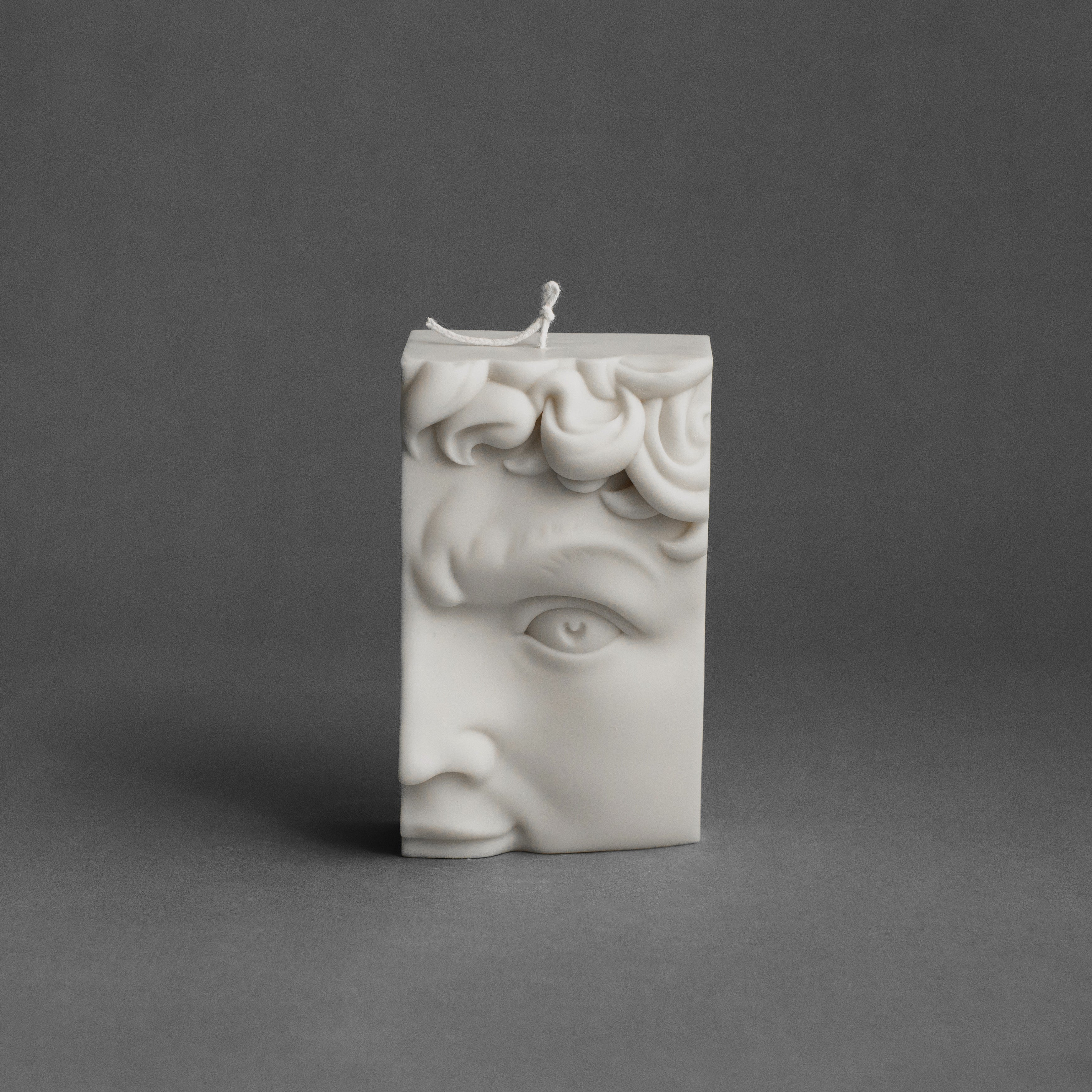 White David’s half face pillar candle by LAWA featuring a sculptural classical profile in soy wax