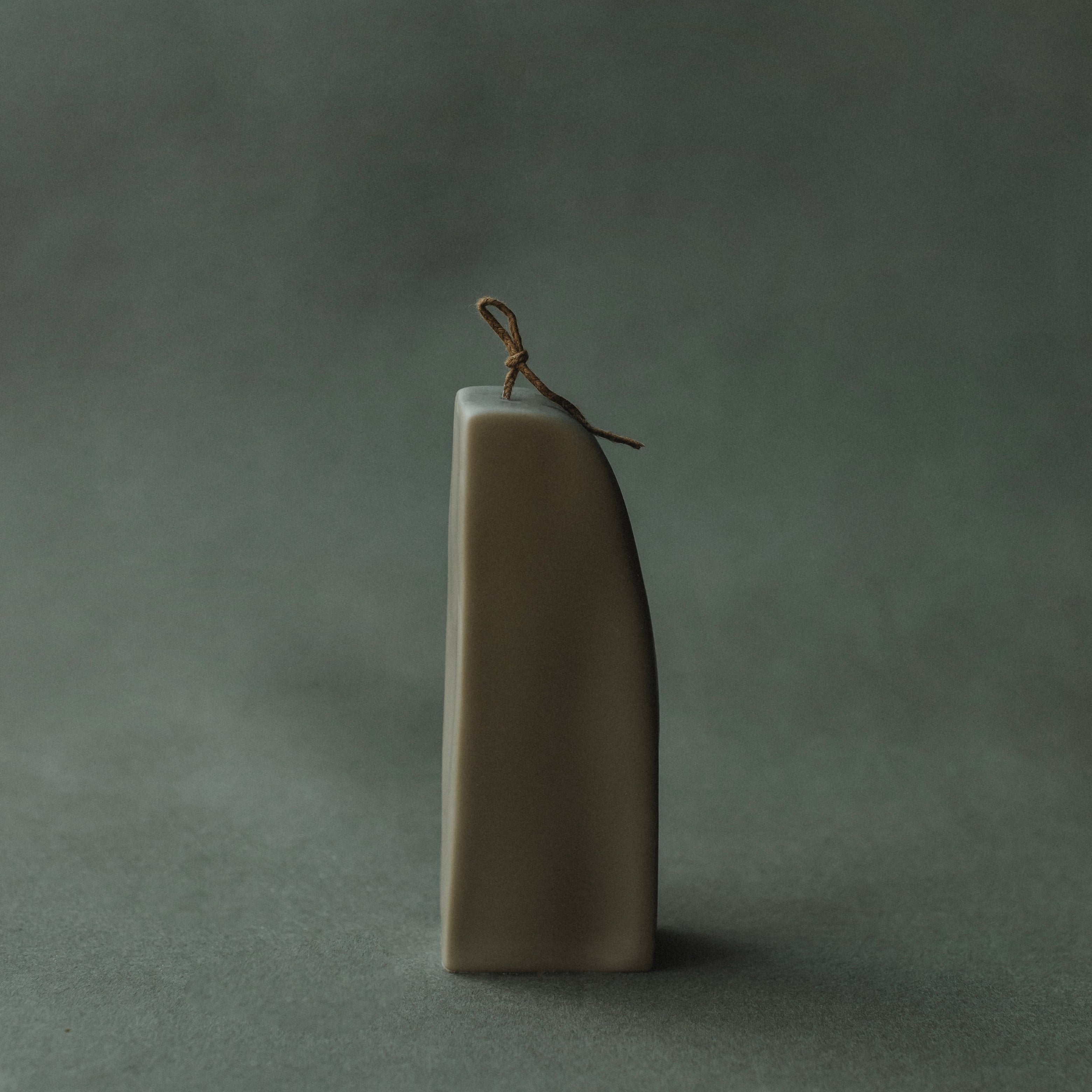 Earthy green downhill sculptural soy wax candle by LAWA with modern curved shape for contemporary decor