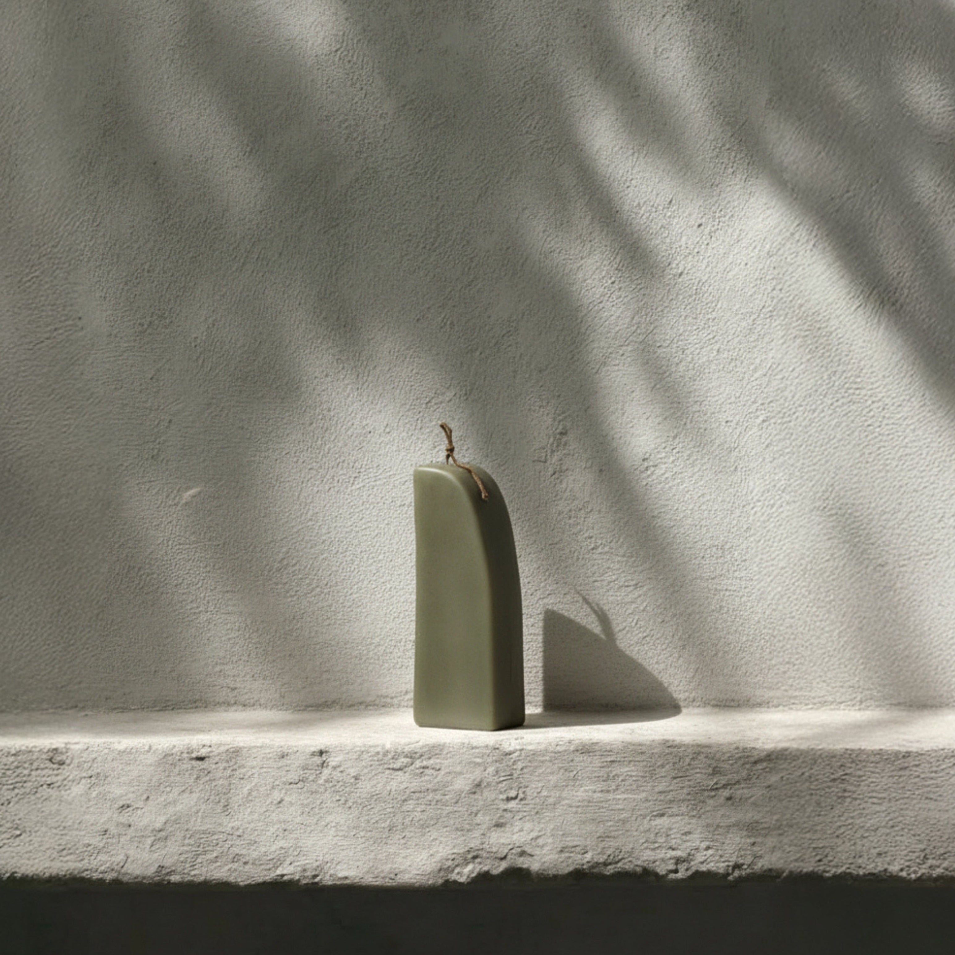 Earthy green downhill sculptural soy wax candle by LAWA with modern curved shape for contemporary decor idea