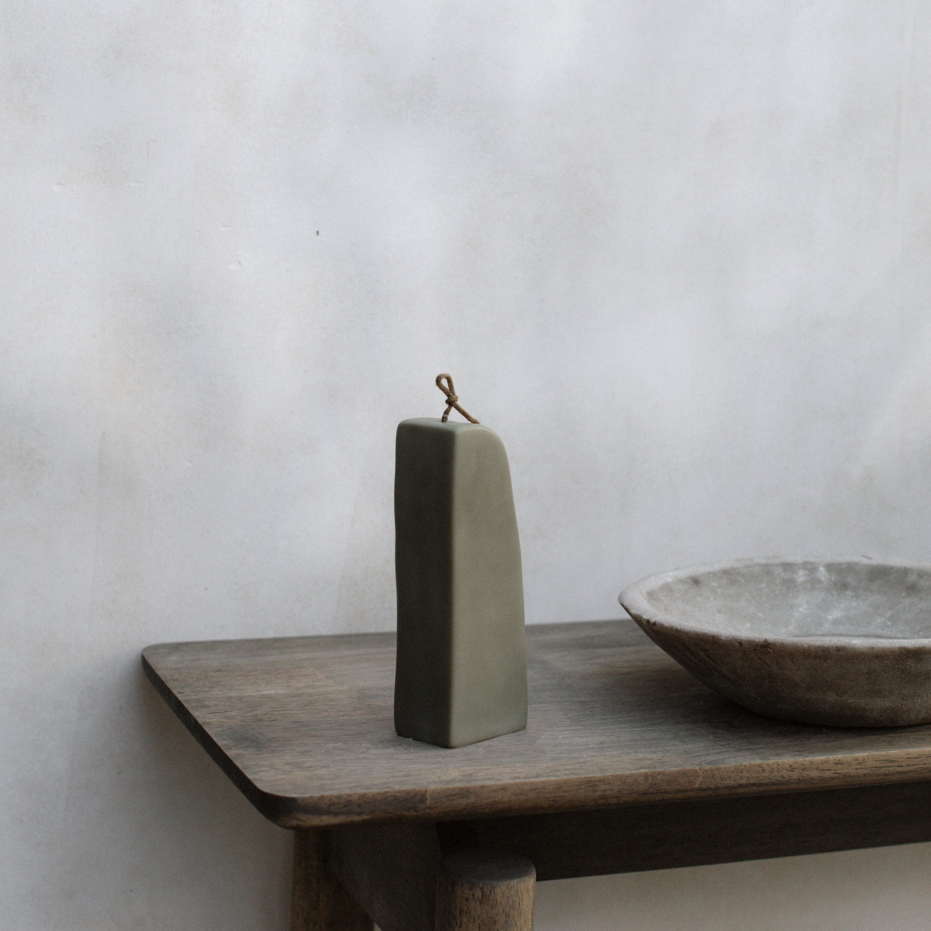 Earthy green downhill sculptural soy wax candle by LAWA with modern curved shape for interesting way of decorating the table