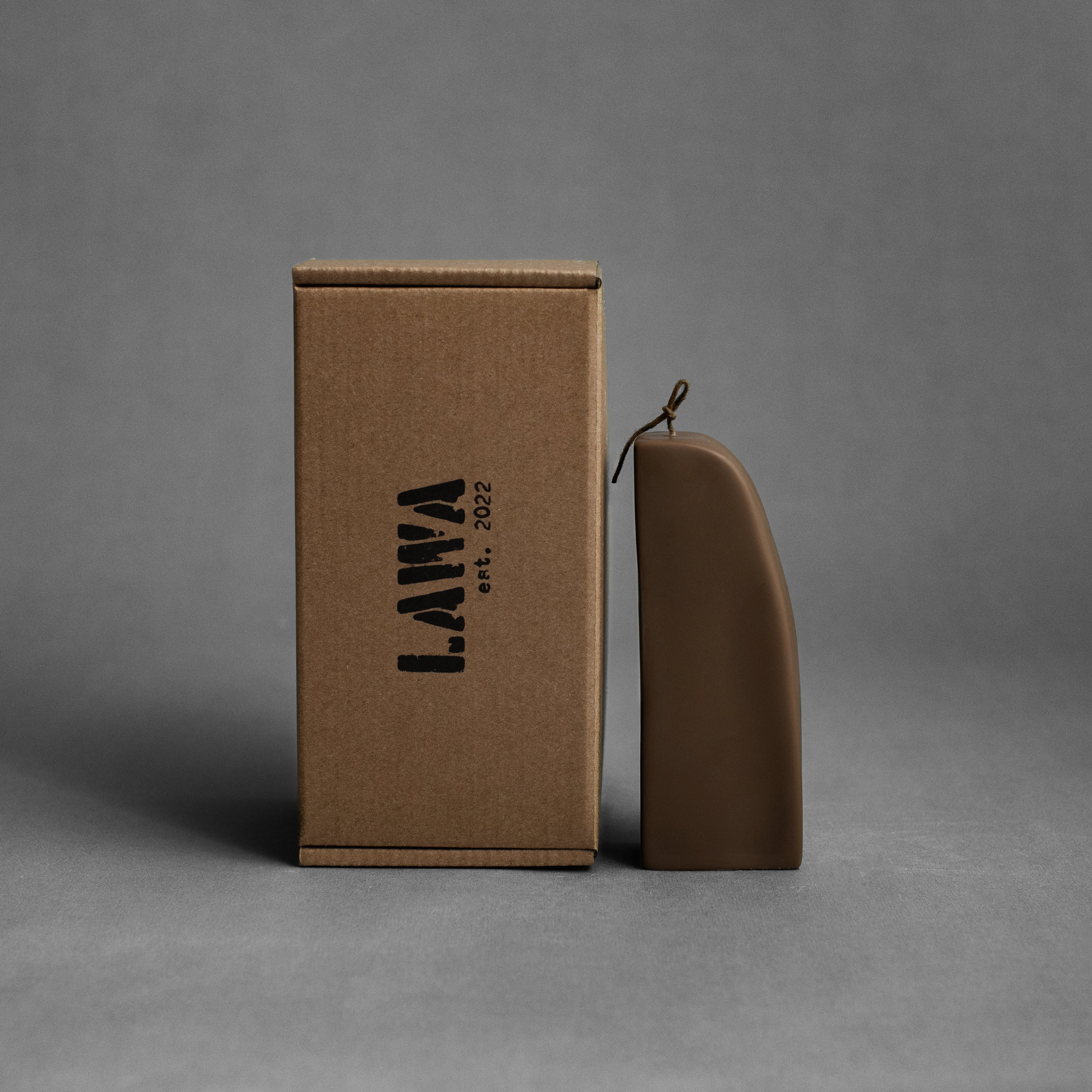 Kobicha brown downhill sculptural soy wax candle by LAWA, modern curved shape for minimalist home decor with the box used for transport the canlde