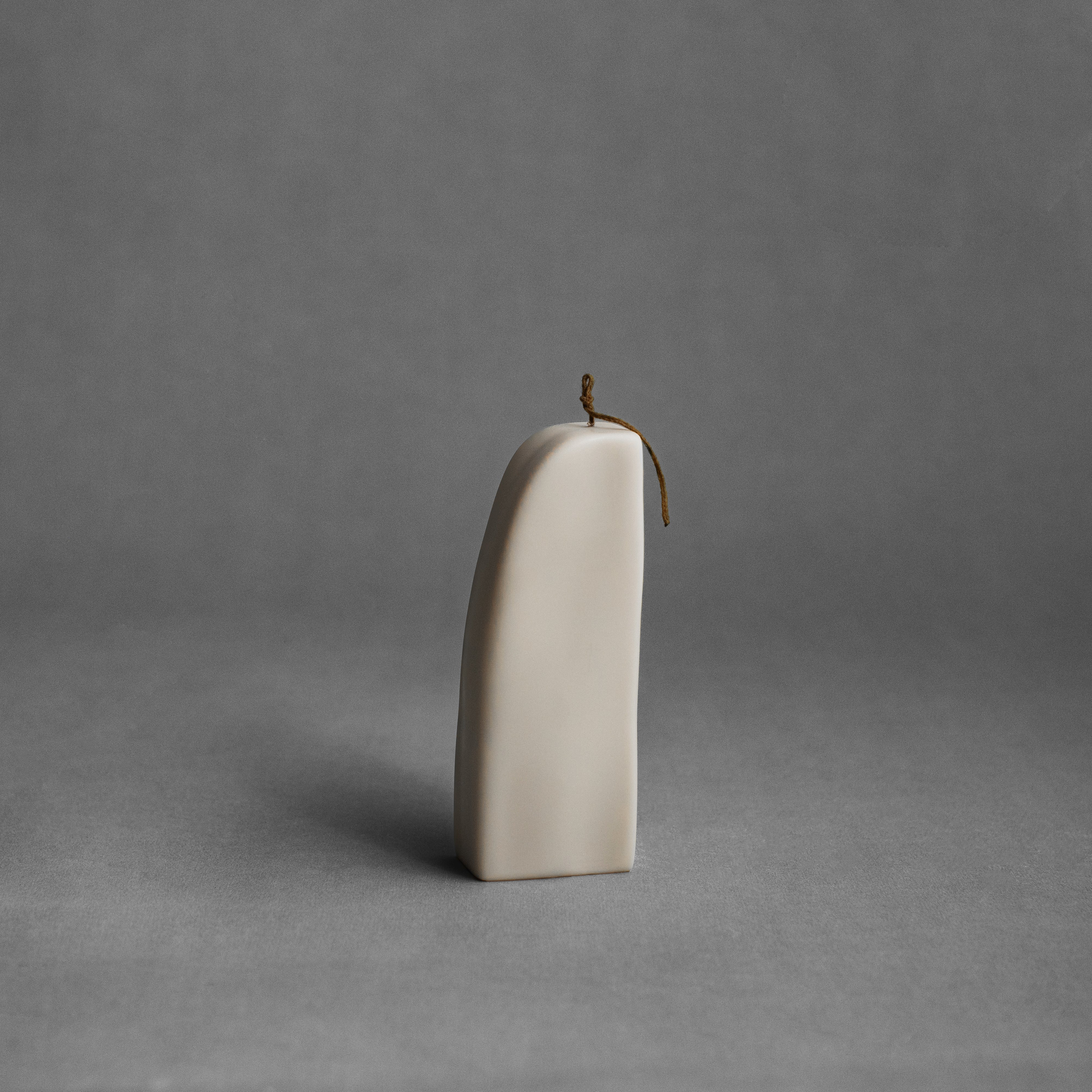 Light beige downhill sculptural soy wax candle by LAWA, modern minimalist decor piece with smooth curved form
