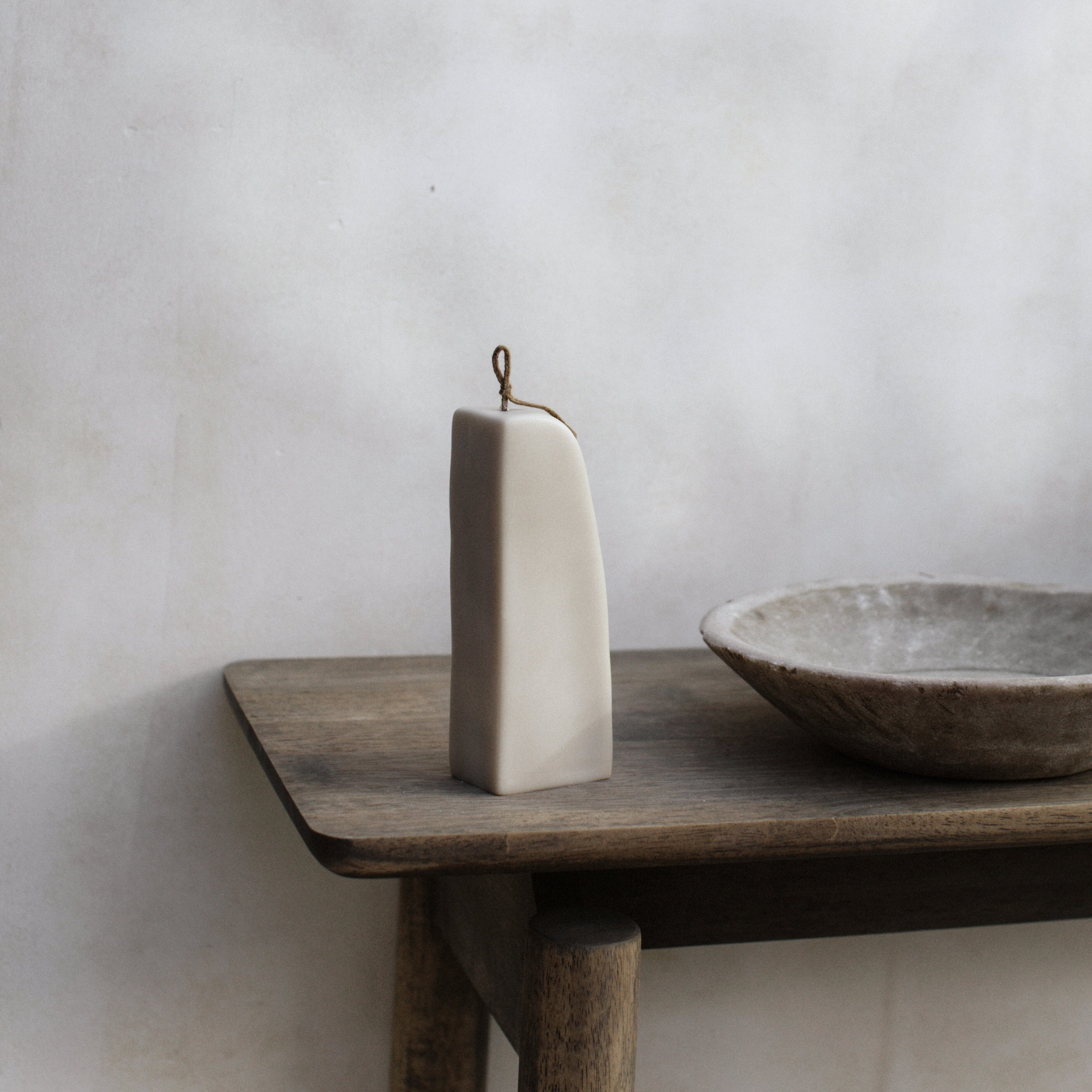 Light beige downhill sculptural soy wax candle by LAWA,as an addition to the table decoration option for home design