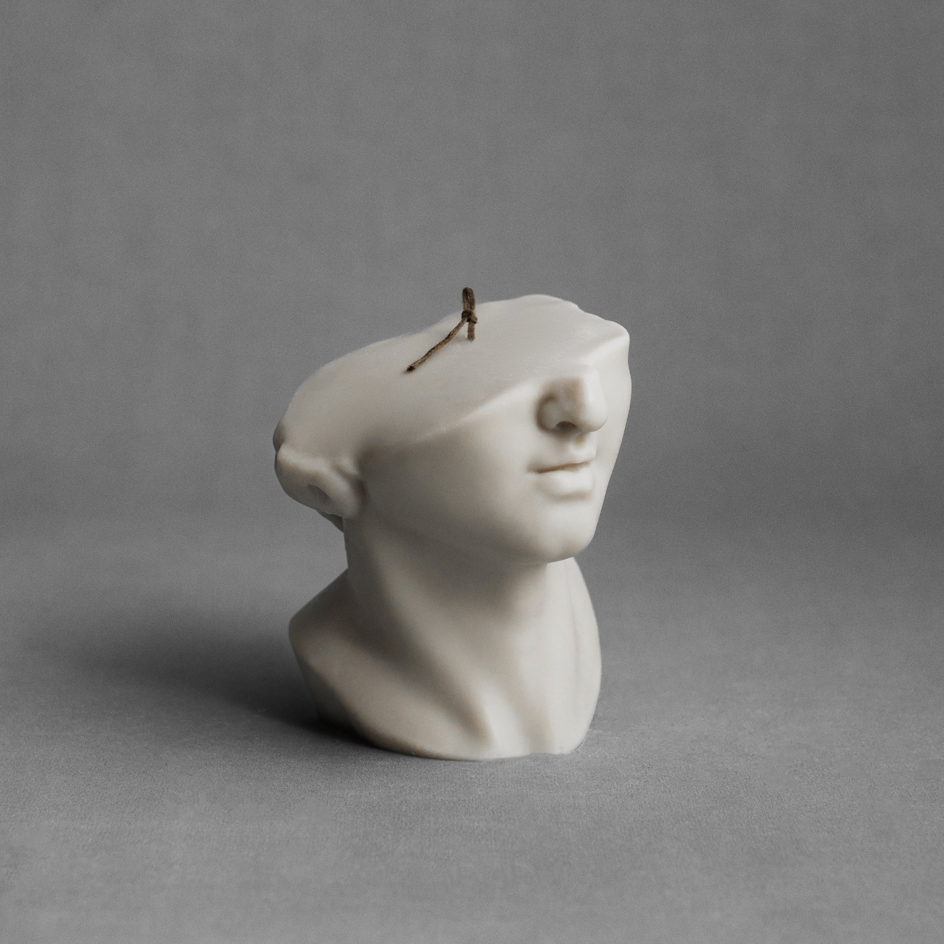 Moon gray Greek statue pillar candle by LAWA featuring a sculptural classical figure in soy wax.