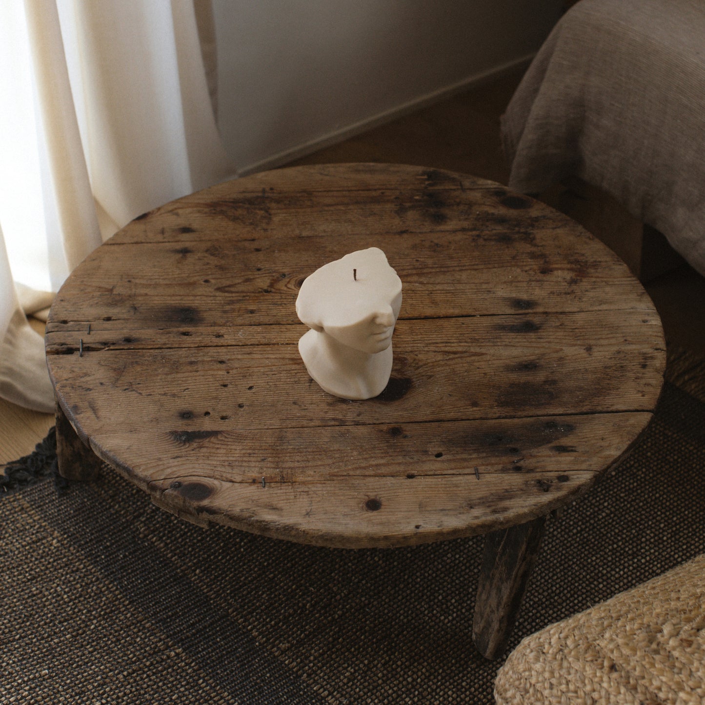 Greek statue sculptural candle handmade from soy wax displayed in modern Los Angeles home setting