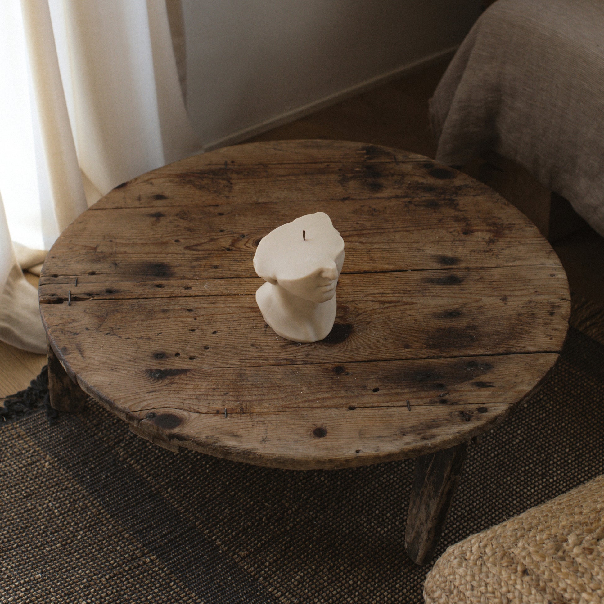 Greek statue sculptural candle handmade from soy wax displayed in modern Los Angeles home setting