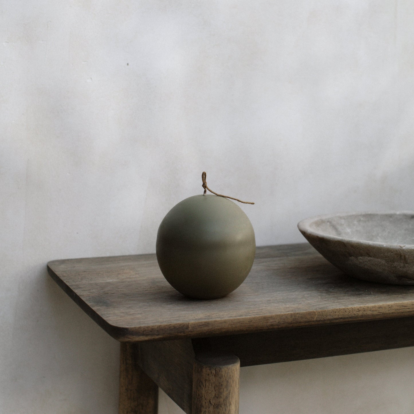 Close-up detail of handmade sculptural candle texture showing premium soy wax surface of Imperfect Sphere design