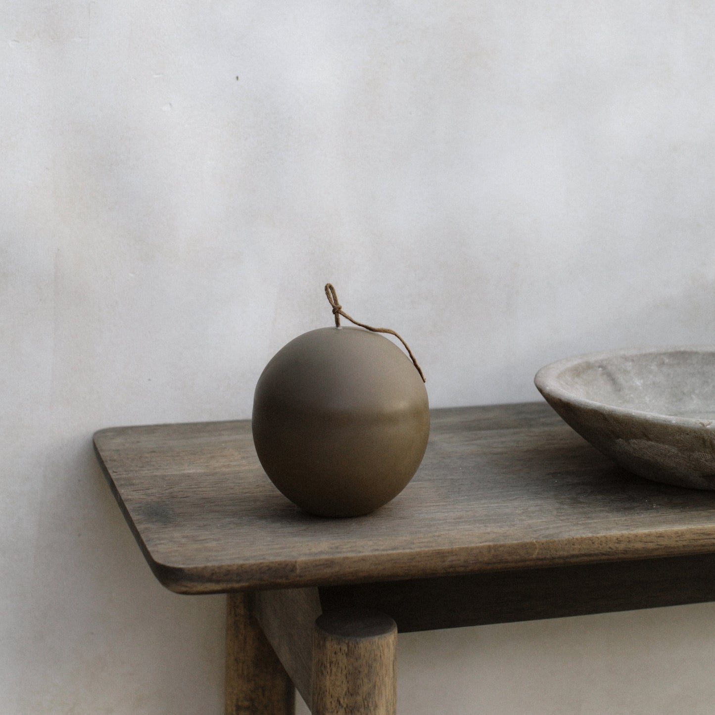Close-up detail of handmade sculptural candle texture showing premium soy wax surface of Imperfect Sphere design