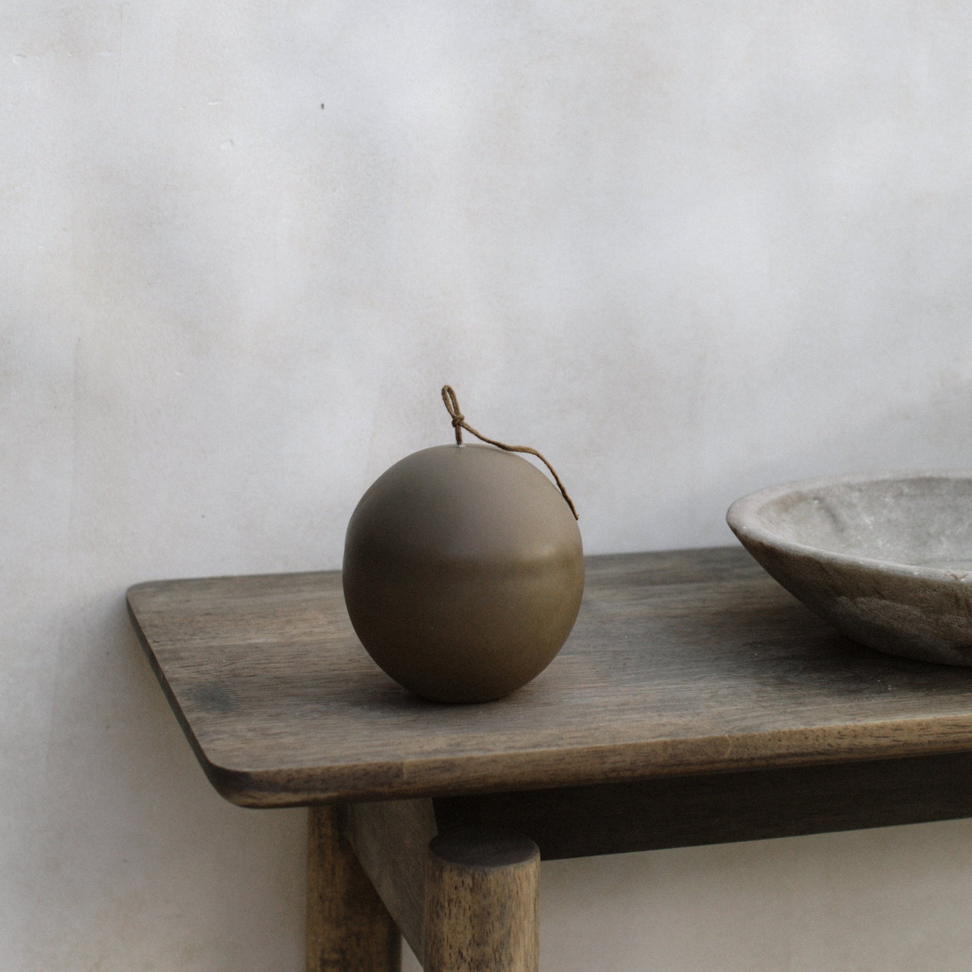 Close-up detail of handmade sculptural candle texture showing premium soy wax surface of Imperfect Sphere design