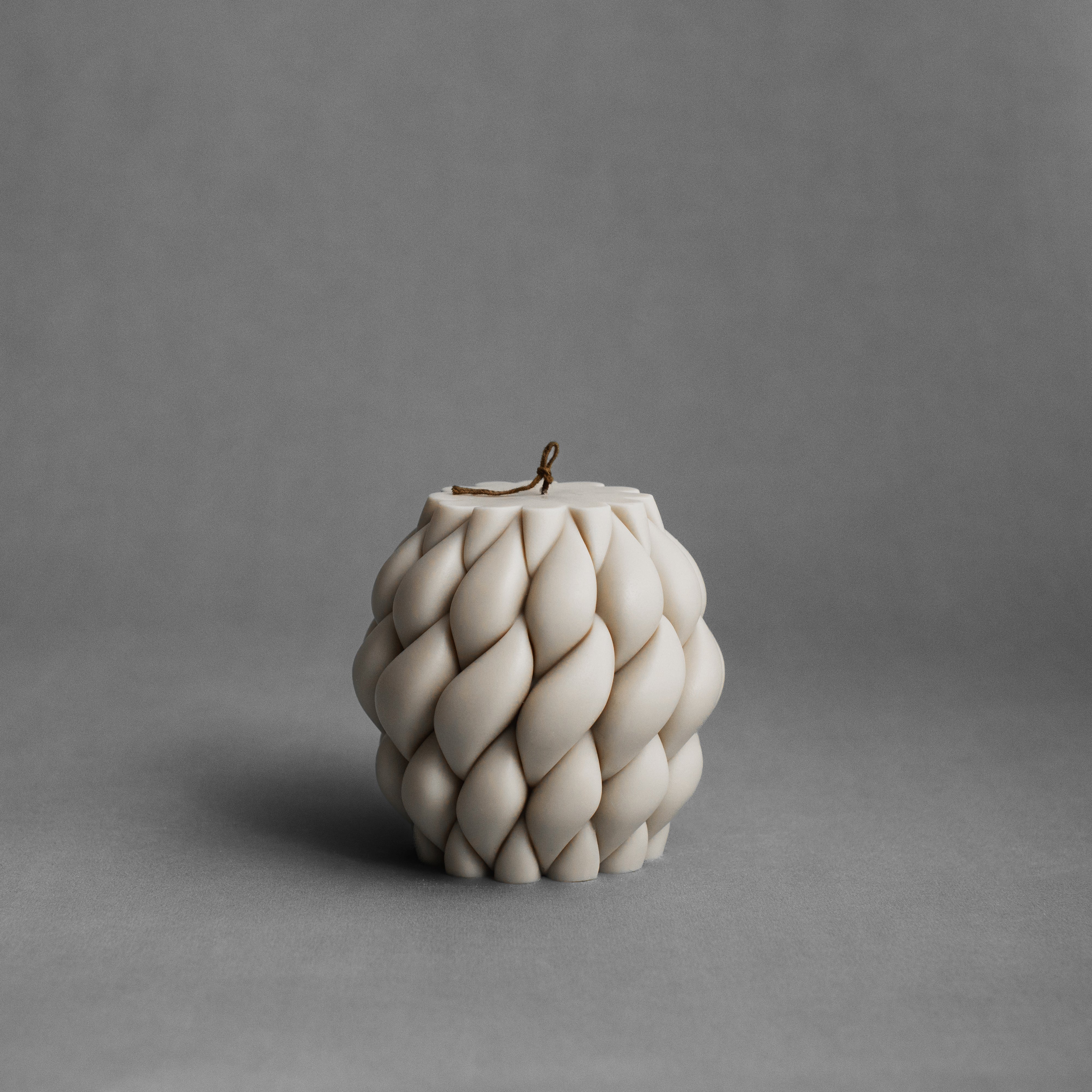 Moon gray knot ball candle by LAWA with a sculptural twisted rope-inspired design