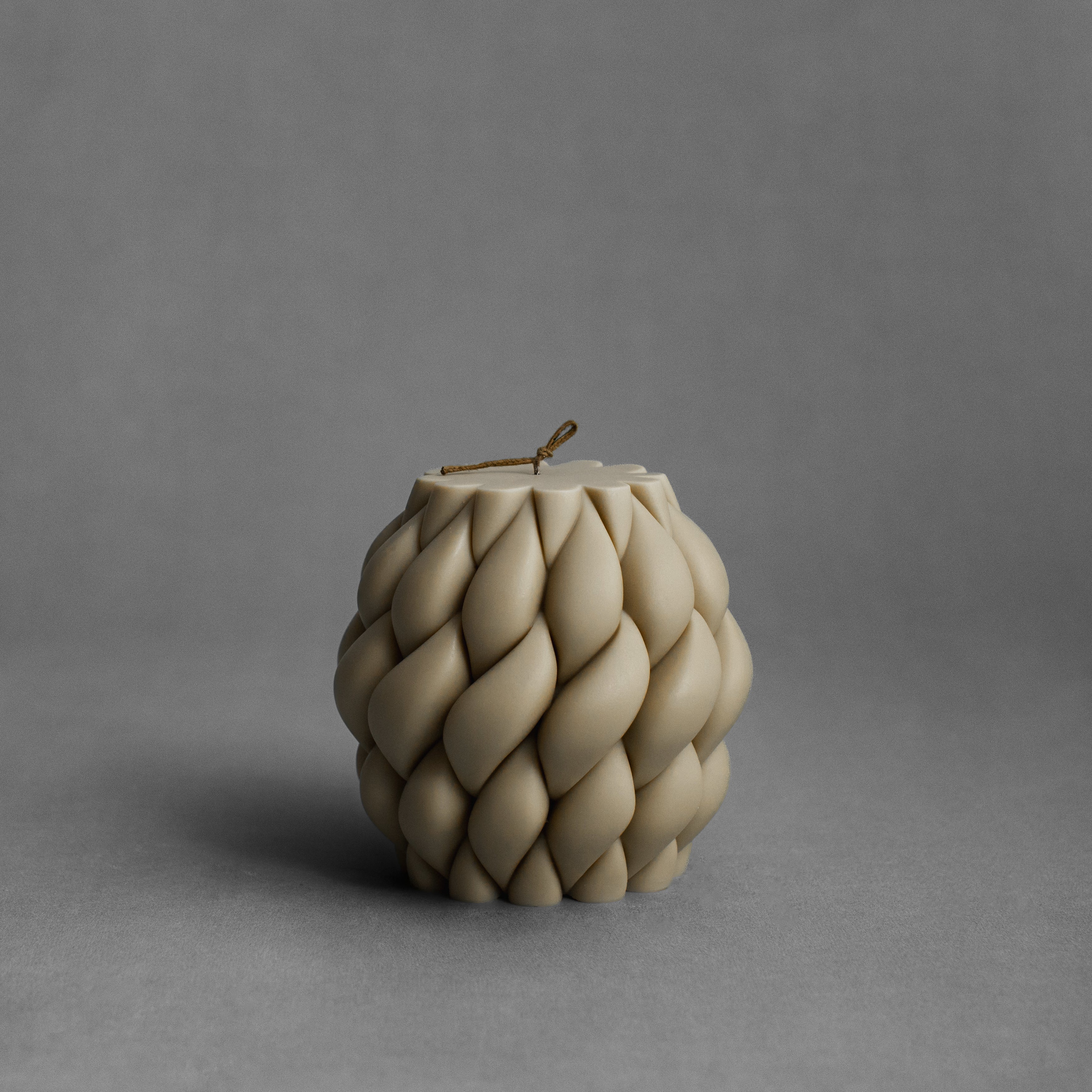 Olive beige knot ball candle by LAWA with earthy intertwined sculptural shape