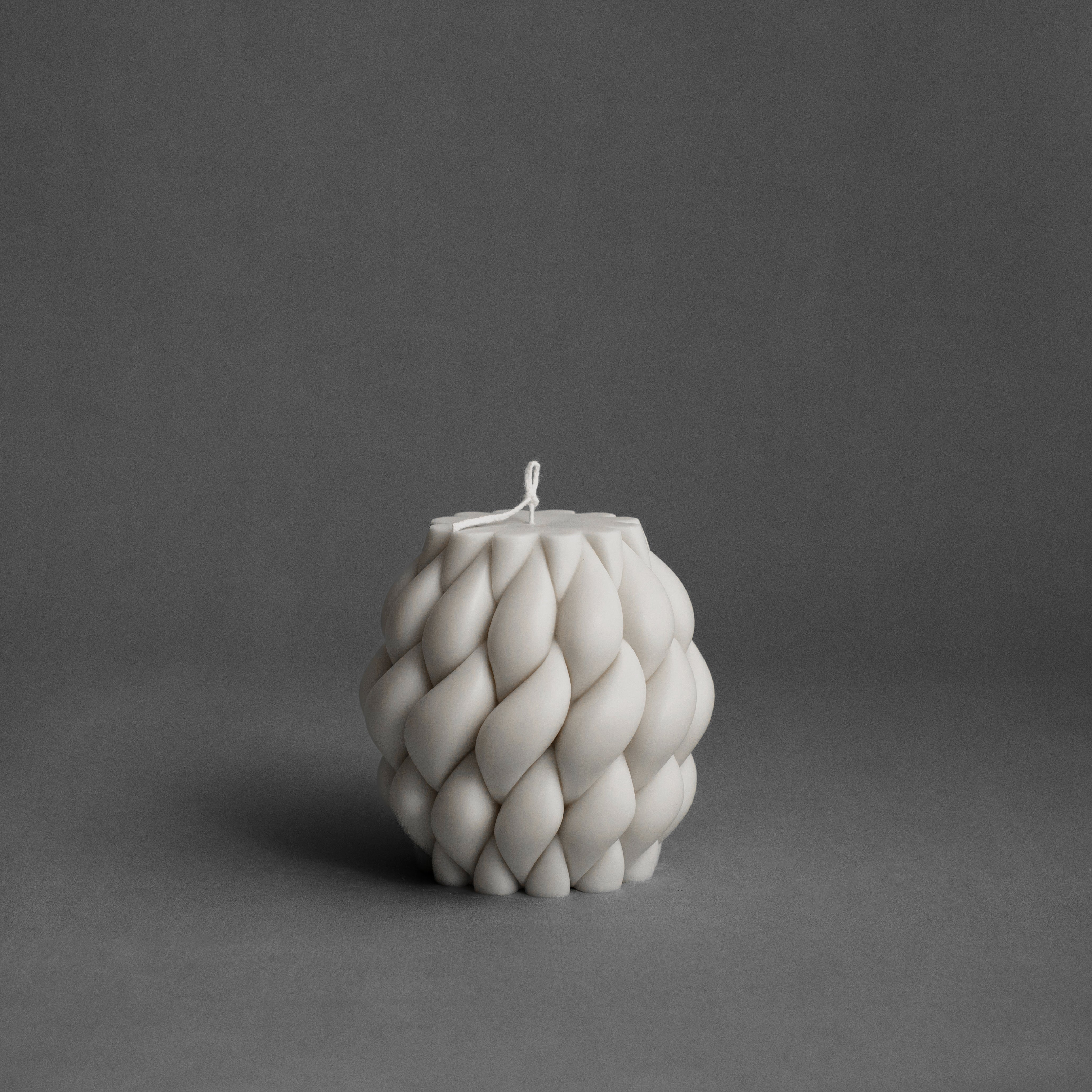 White knot ball candle by LAWA featuring an intricate twisted design in clean soy wax