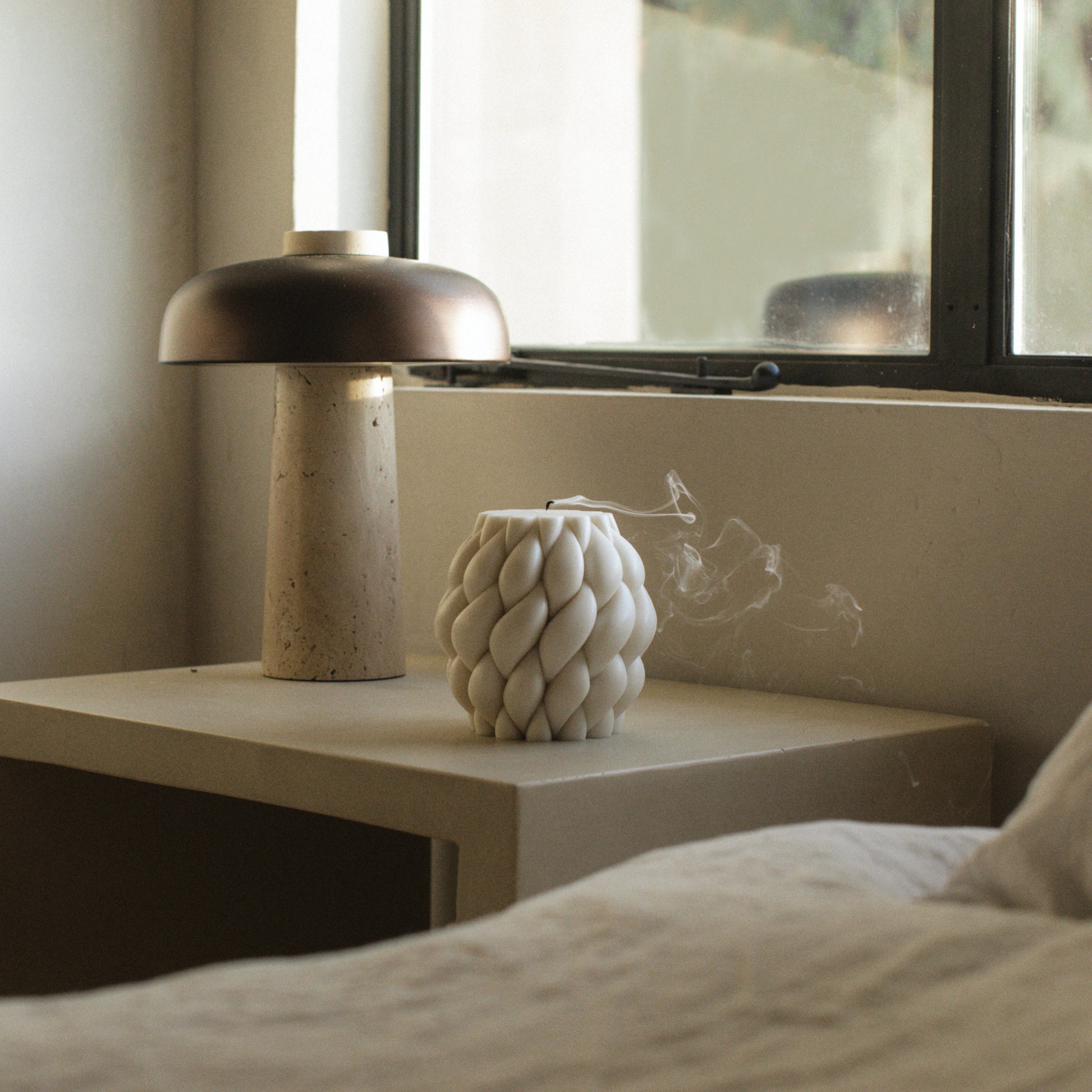 Close-up detail of handmade Knot Ball sculptural candle showing premium soy wax texture and cotton wick