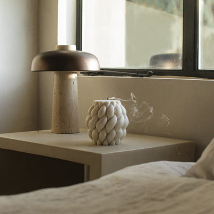 Close-up detail of handmade Knot Ball sculptural candle showing premium soy wax texture and cotton wick