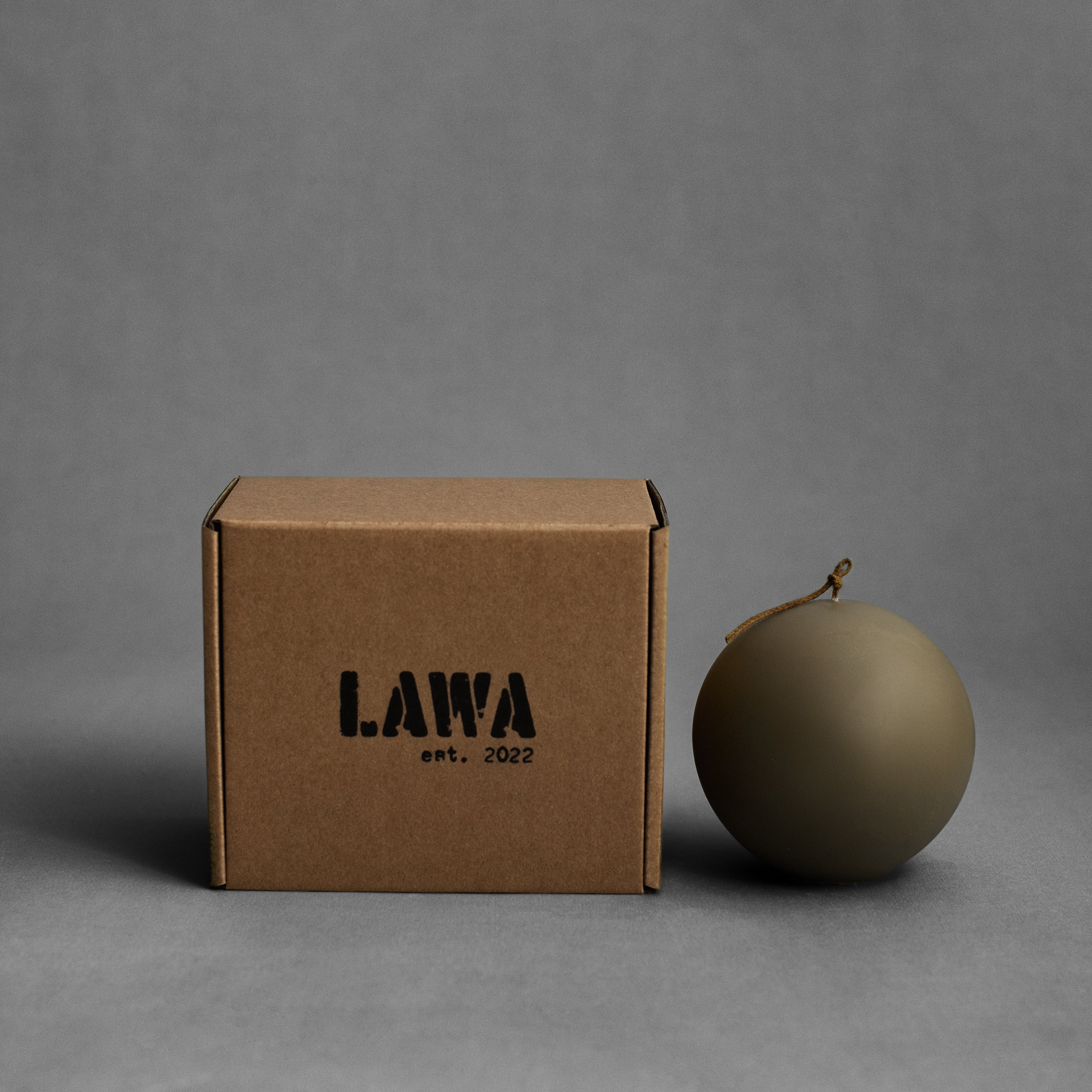 Large earthy green sphere soy wax pillar candle by LAWA, modern rounded sculptural shape for natural decor with packaging shipping box