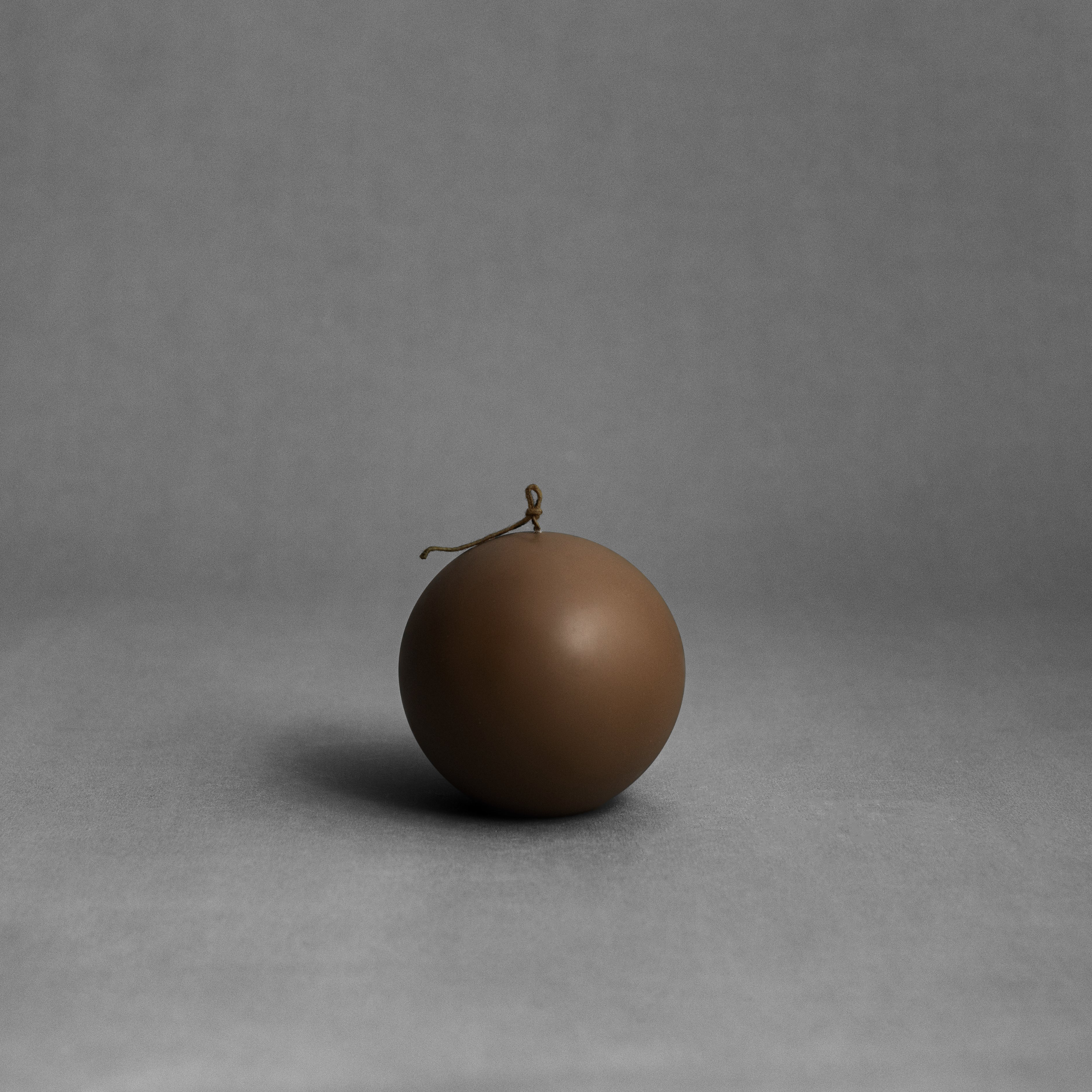 Large kobicha brown sphere soy wax pillar candle by LAWA with rounded sculptural silhouette