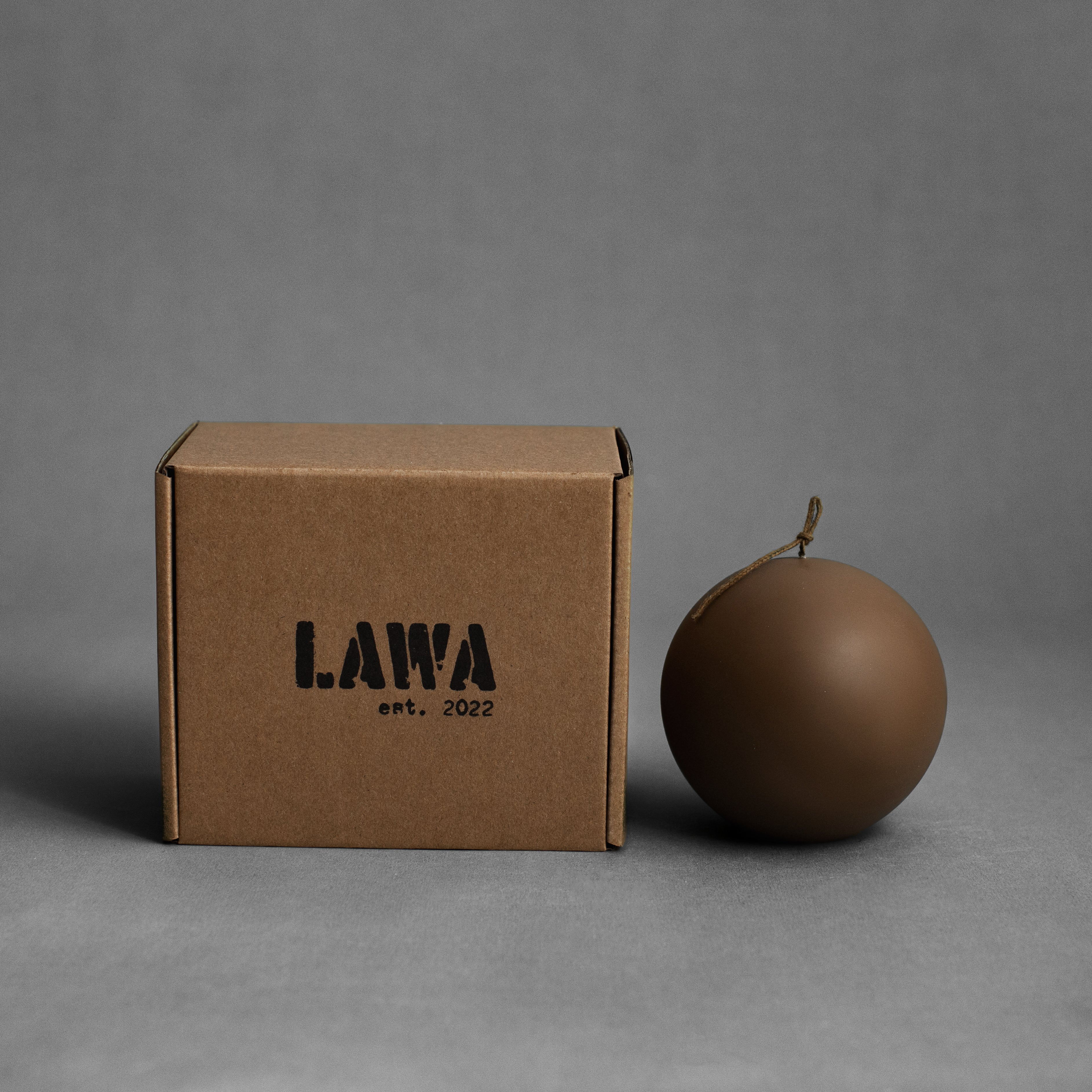 Large kobicha brown sphere soy wax pillar candle by LAWA with a rounded sculptural silhouette, with the box 