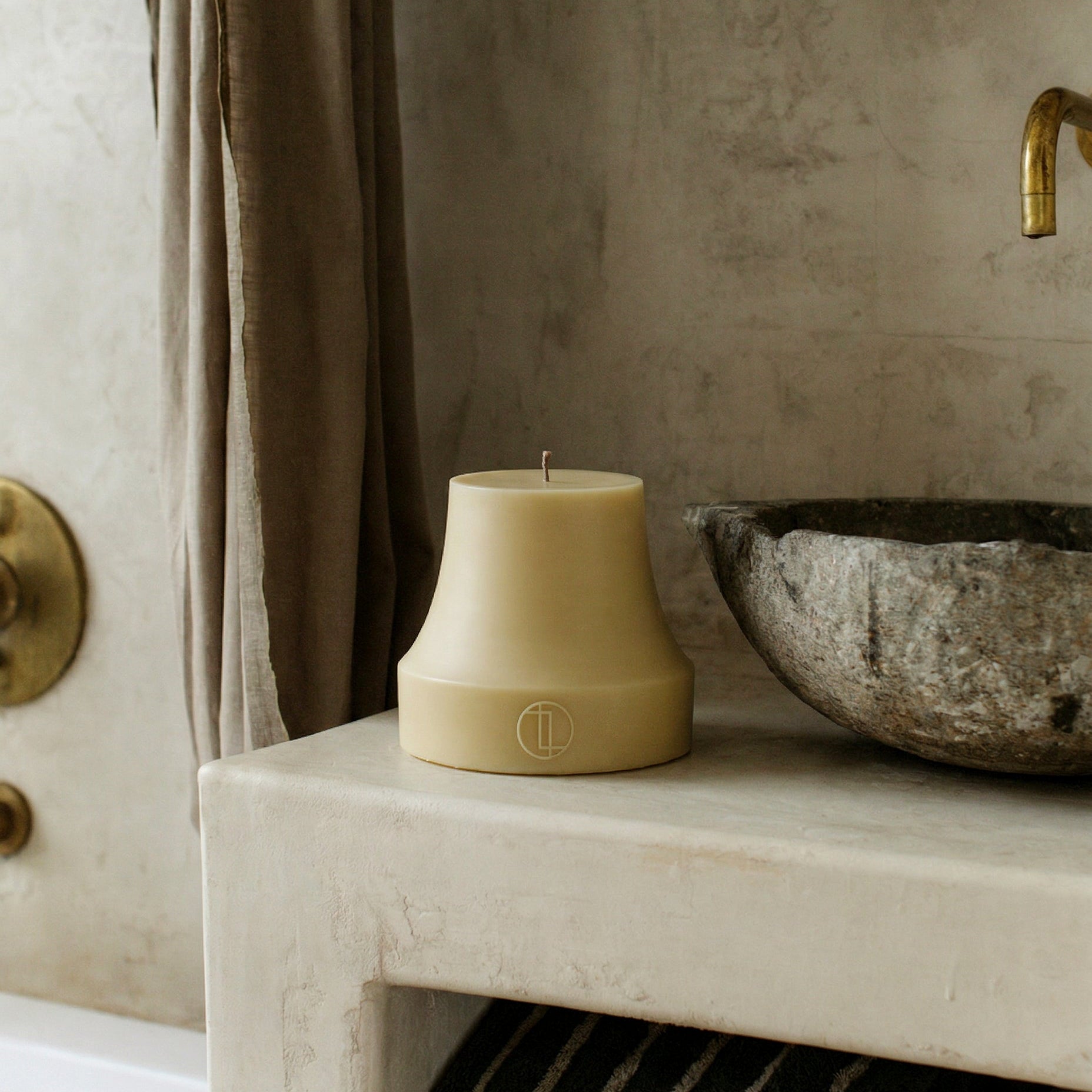 Close-up detail of handmade bell sculptural candle showing smooth soy wax texture and organic curves