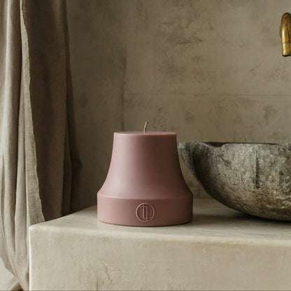 Close-up detail of handmade bell sculptural candle showing smooth soy wax texture and cotton wick