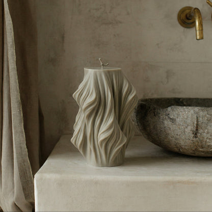 Close-up detail of handmade sculptural candle showing cascading wave texture in premium soy wax from Los Angeles