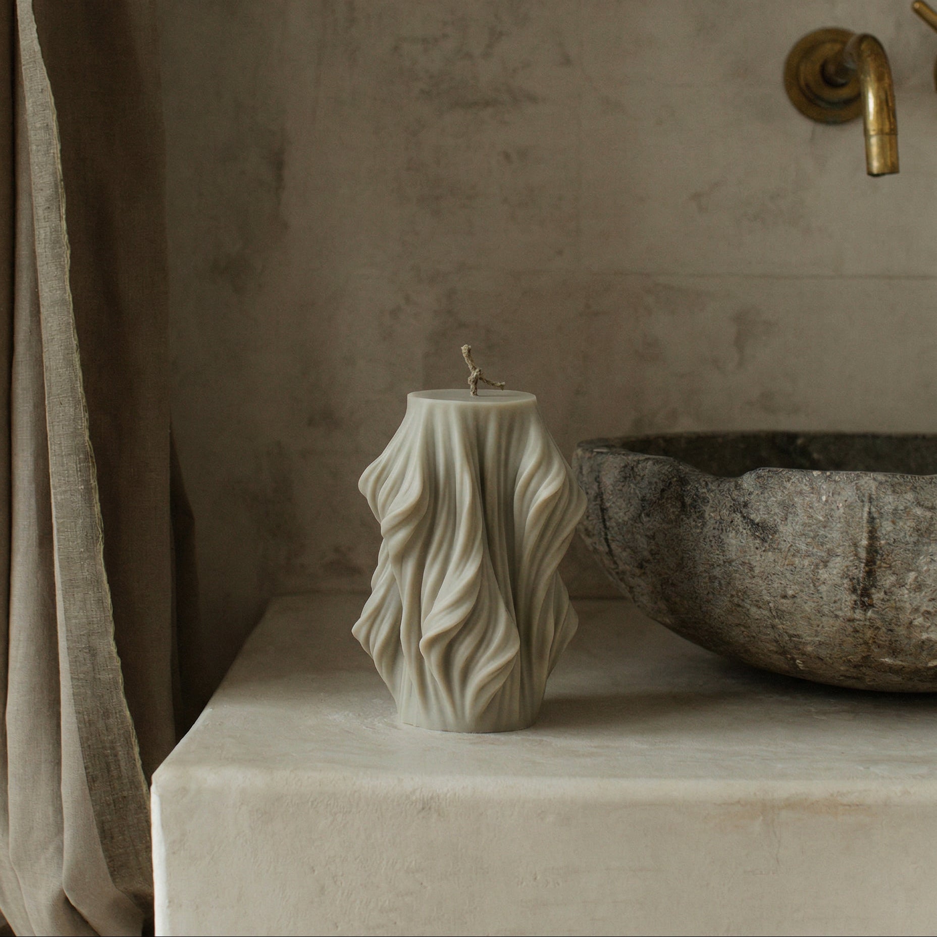 Close-up detail of handmade sculptural candle showing cascading wave texture in premium soy wax from Los Angeles