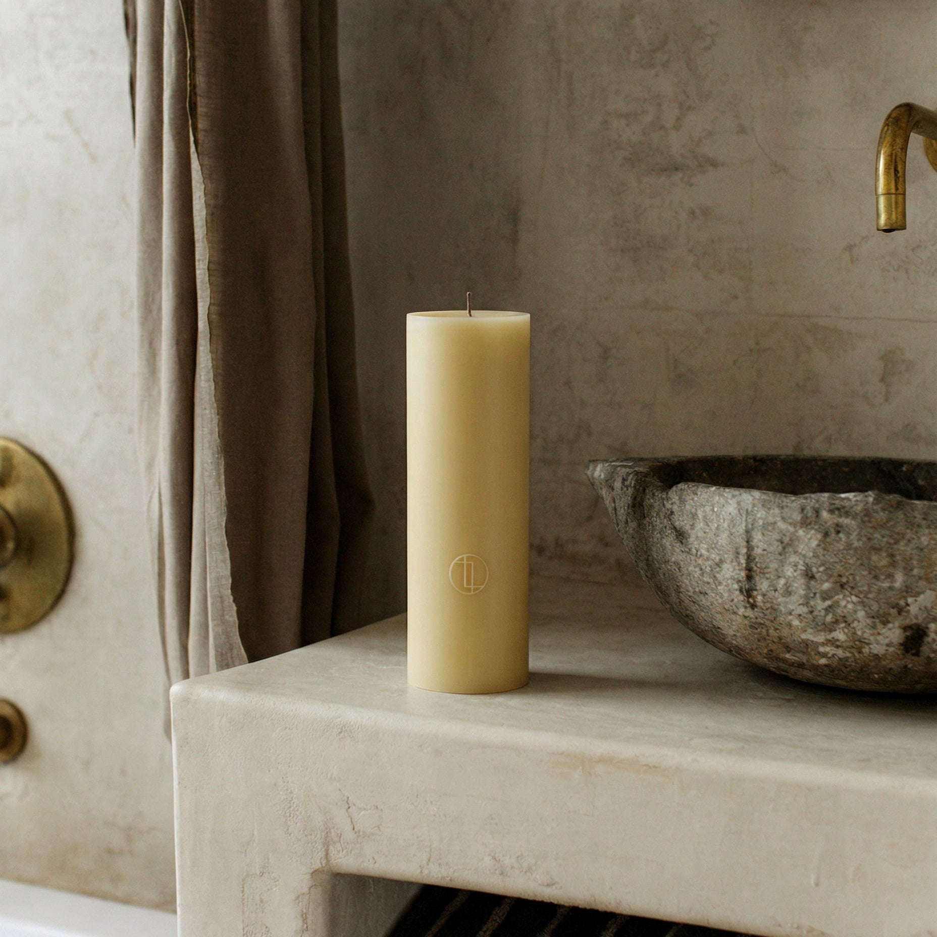 Close-up detail of handmade unscented cylinder candle showing smooth soy wax texture and cotton wick