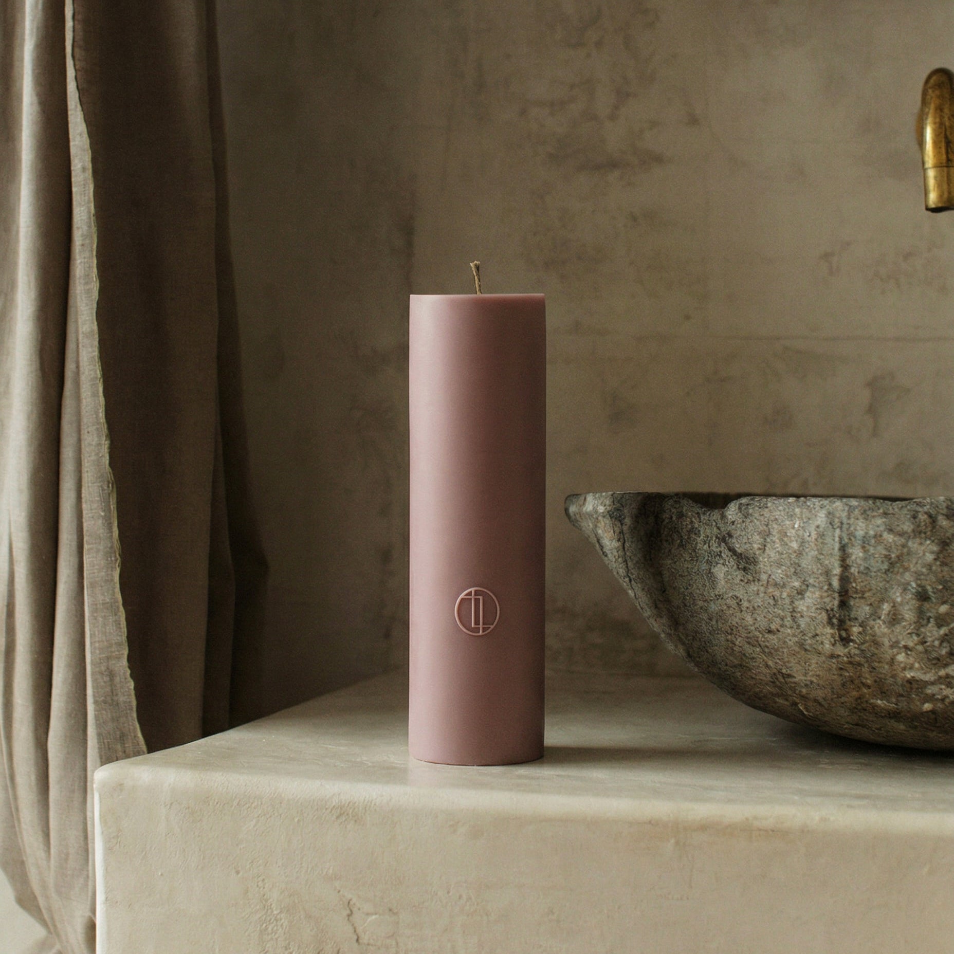 Close-up detail of handmade cylinder candle showing smooth soy wax texture and cotton wick in Los Angeles studio