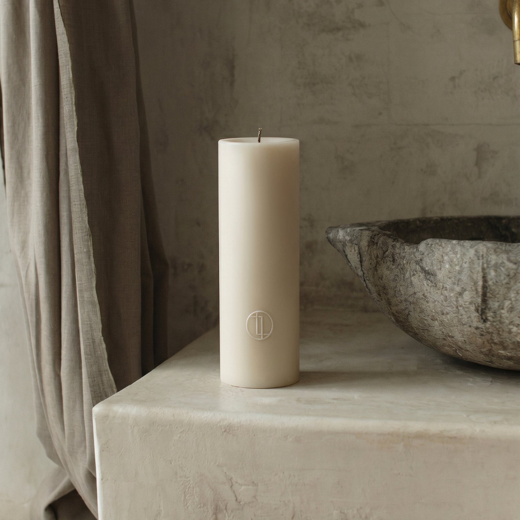Close-up detail of handmade unscented cylinder candle showing smooth soy wax texture and cotton wick