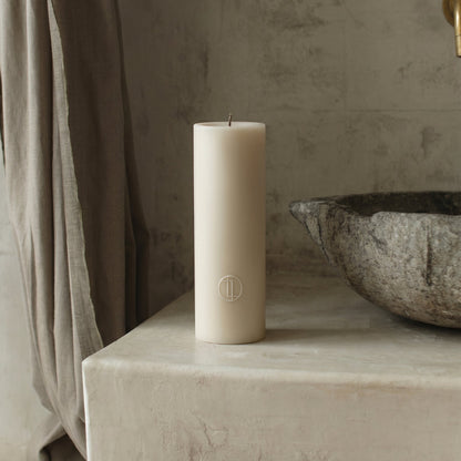 Close-up detail of handmade unscented cylinder candle showing smooth soy wax texture and cotton wick