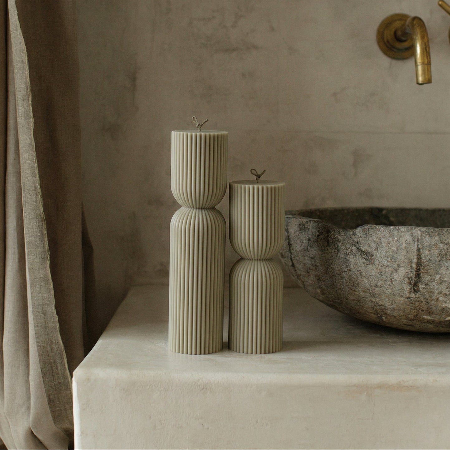 Close-up detail of handmade hourglass sculptural candle texture showing premium soy wax surface in natural light