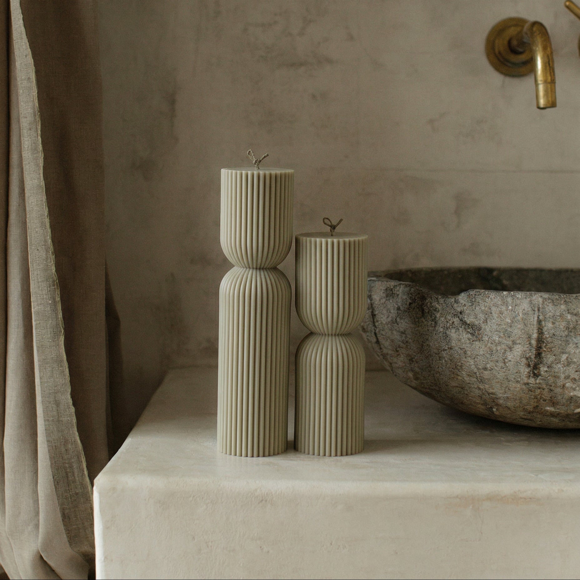 Close-up detail of handmade hourglass sculptural candle texture showing premium soy wax surface in natural light